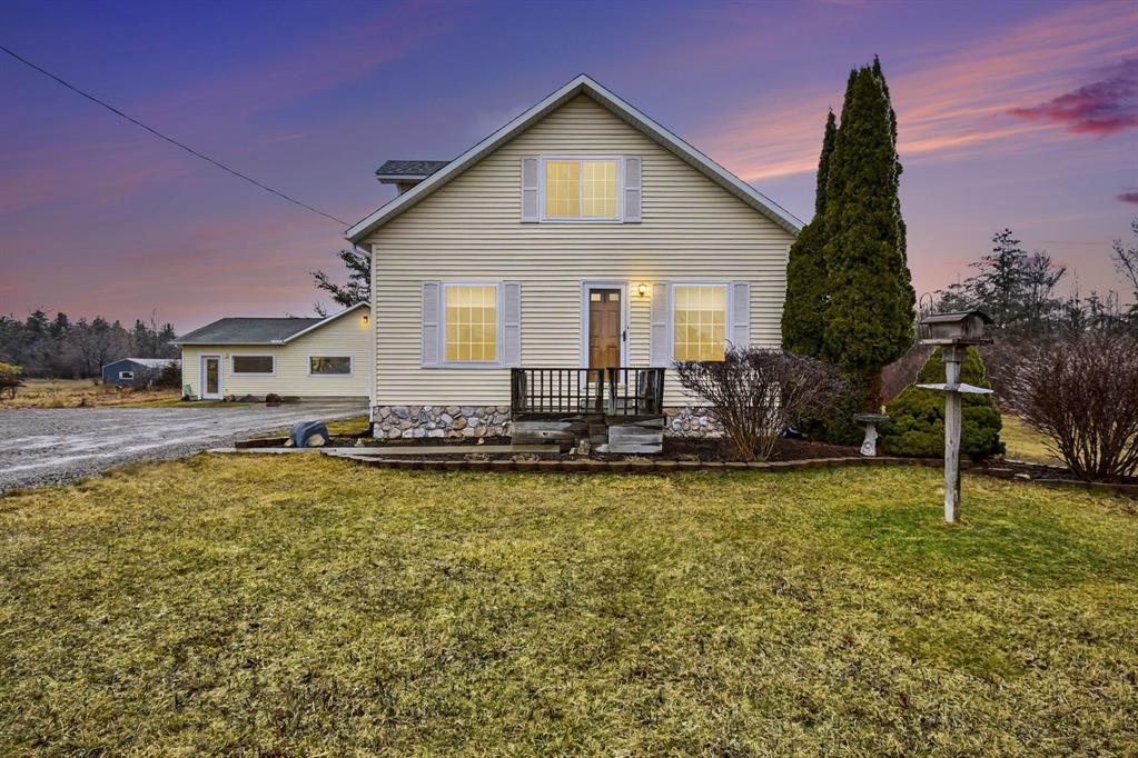 Charming Farmhouse Oasis in Tawas City! Welcome to your dream retreat at 1400 W. M - 55, Tawas City. This completely renovated farmhouse beautifully combines modern luxury with classic charm all set on an expansive 13.65 acres of picturesque land. This home includes 3 inviting bedrooms and 2 full baths featuring a convenient main floor bedroom and bath for easy accessibility. Create culinary masterpieces in your stunning kitchen, equipped with stainless steel appliances and elegant granite counter tops perfect for entertaining family and friends. Enjoy the elegance of selective crown molding in key areas complemented by all new flooring throughout the home. Whether you're practicing your swing on the 150 yard golf range or exploring the walking/bike trails, this property is designed for outdoor enthusiasts. There is a quaint, vintage barn that adds so much character to the professionally landscaped grounds. The 24 x 28 detached garage comes with an attached office, ideal for a home office, man cave, workout room, or tailoring to your lifestyle! There's space for 6+ vehicles making it easy to host guests and embark on outdoor adventures. Unwind on the spacious deck soaking in panoramic views of your expansive property. A new (2026) furnace efficiency while an external disconnect for a generator offers peace of mind during rough weather. This property is not just a home, it's a lifestyle waiting for you to embrace! Don't miss your chance to own this slice of paradise! Schedule your private showing today!