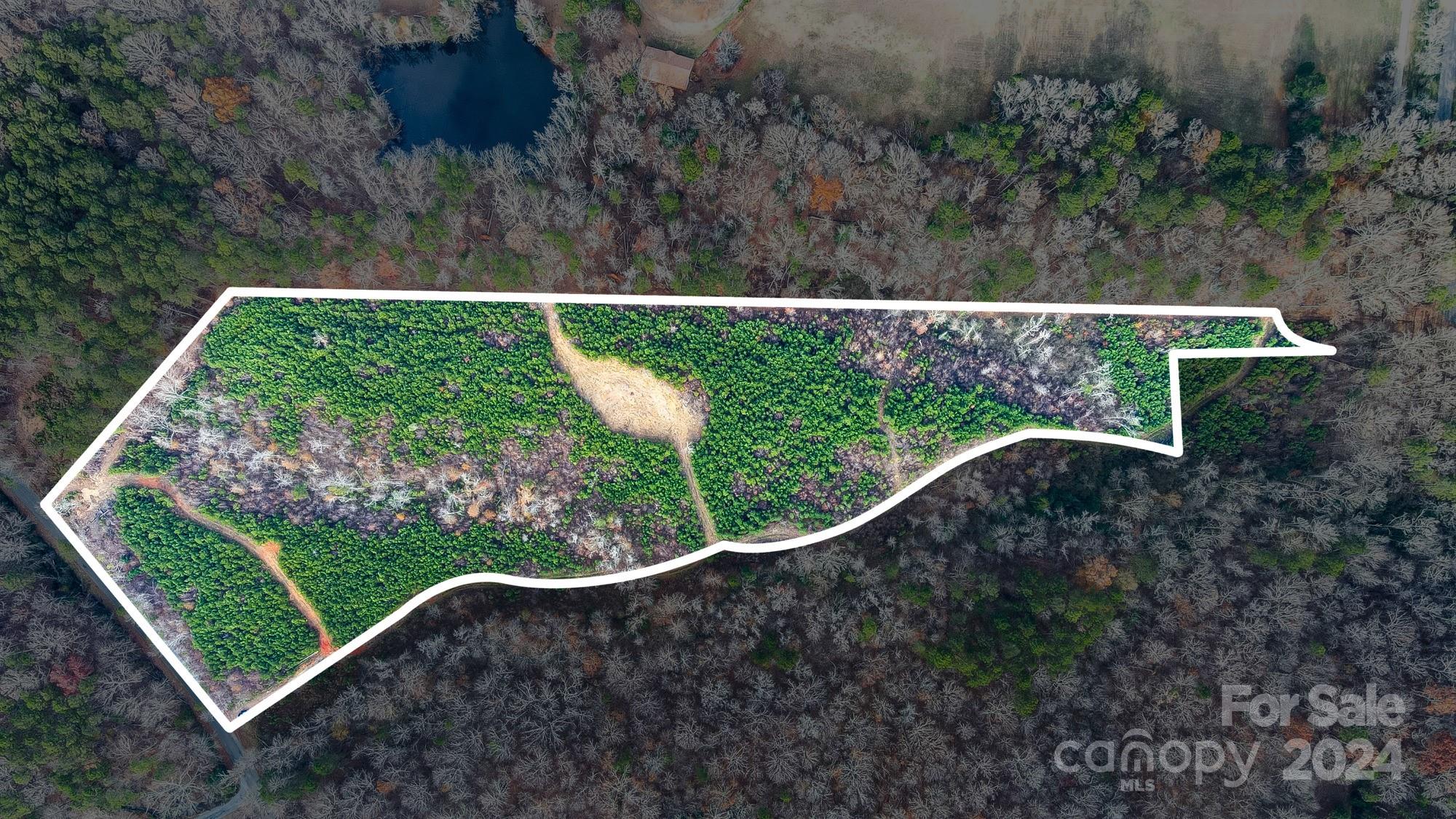 Breathtaking 14.19 acres in Norwood that borders Oak Road and Anchor Road.  This is a perfect property for someone that enjoys the outdoors. The property has city water and sewer available to tap on.  Approximately 12 acres are wooded and 2 cleared.  Anchor Road entrance is across the road from Lake Tillery and one home could be built across the street from the lake.  The seller believes he has 3 good sites available for building a home.
Timber was harvested in 2017 and replanted. 
Anchor Road has a 50 foot deeded tight away.

Be sure and watch the drone video.