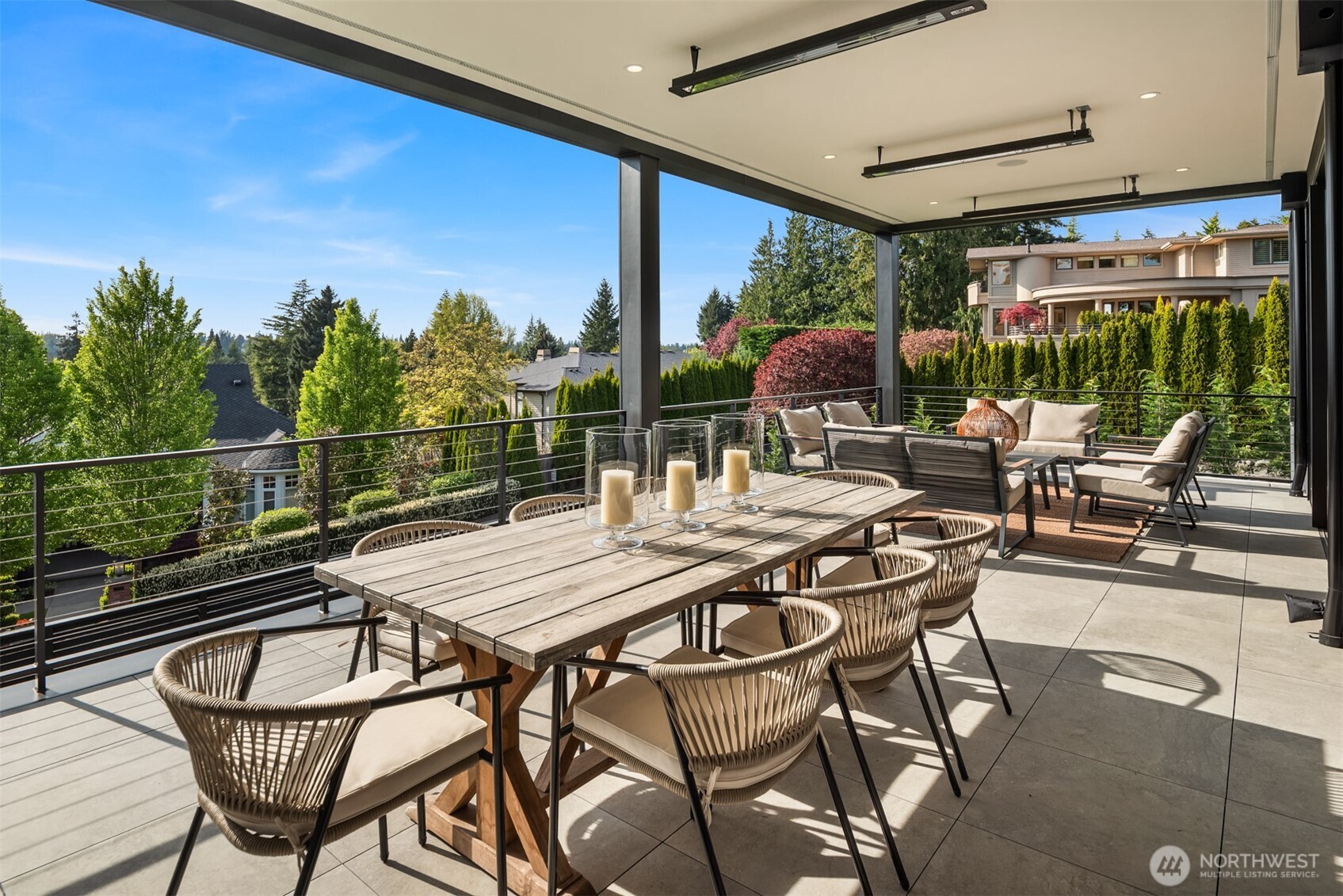 Expansive covered terrace offers year-round entertaining with multiple seating areas and tranquil views.