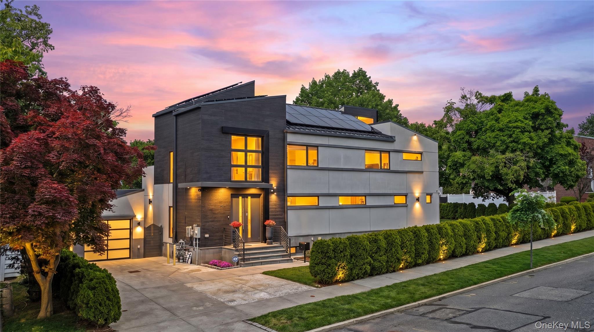 Set on an approximately 6,000 SF corner lot, this luxury detached residence offers approximately 3,000 SF of interior space with a rare blend of scale, privacy, modern design, and fully customized details. Built in 2019, the home features 4 bedrooms, 5 bathrooms, a finished basement, and a finished walk-up attic, creating a spacious and flexible layout for comfortable living, entertaining, and extended family needs.Thoughtfully designed with character and taste, the residence showcases high-quality finishes, generous room proportions, and carefully selected upgrades throughout. Three bedrooms offering excellent privacy and convenience. The primary suite features a high ceiling, private balcony, and access to a finished attic through an automatic pull-down staircase, creating additional recreation or flexible-use space. Outdoor living is further enhanced by a first-floor patio, 2 second-floor balconies, and terrace space.The kitchen is one of the home’s standout features, designed for both daily use and entertaining. It includes quartz countertops, a large kitchen island with an extra electric cooktop, steam cooking capability, premium Wolf, Bosch, and Fisher & Paykel appliances, multiple refrigerators, 2 dishwashers, a microwave, warming drawer, gas range, induction cooktop, and in-wall ventilation. The layout and appliance package create a refined, highly functional cooking space with a true custom feel.The finished basement offers approximately 9-foot ceilings, radiant heated floors, 2 wine coolers, and generous open space ideal for recreation, gatherings, entertaining, or additional storage. The first floor and basement feature gas-powered radiant heated floors, while the second floor includes gas baseboard heating. Additional modern comfort features include Andersen windows, 5-zone climate control, 2 HVAC units, and central air.A fully paid-off solar system adds energy efficiency and long-term value. Exterior highlights include a separate garage, private driveway parking, garden sprinkler system, and snow blower equipment. Conveniently located near the LIRR, this home delivers luxury, space, privacy, modern systems, and thoughtful design in one complete offering.