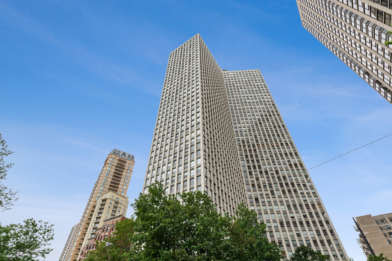 Spacious and sun-filled, this southeast corner 3-bedroom, 2.5-bath condo sits on the 15th floor of a full-amenity building in the heart of Lincoln Park. Enjoy sparkling lake views by day and a stunning downtown skyline at night. At approximately 1,500 sq ft, this original true three-bedroom floor plan features an oversized living and dining room-ideal for entertaining, large furniture, or even a grand piano. The separate dining room is just off the kitchen for easy flow. The primary suite offers expansive lake and south views, a large custom walk-in closet, wall builtins and en-suite bath. The second bedroom is perfect for guests with a full bath just across the hall, while the third bedroom is currently used as an office/library. Additional highlights include hardwood floors, generous organized closet space, individual thermostats in each room, blinds throughout, and the potential to install an in-unit washer/dryer with building approval. The building offers 24-hour door staff, leased garage parking, an outdoor pool, rooftop deck with grills and picnic areas, fitness center, bike storage, on-site dry cleaners, and laundry room. Smoke-free and pet-friendly. This home is neutral, warm, inviting-and ready for your design ideas.