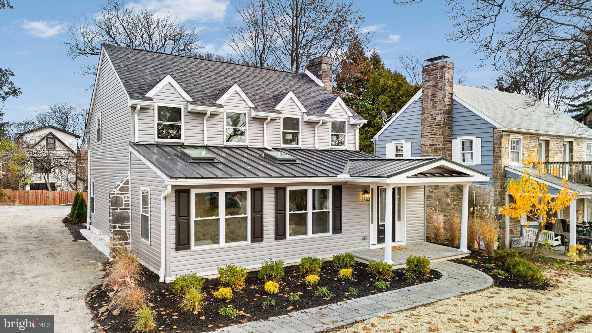 Welcome to 211 Bryn Mawr Avenue, an exceptional and fully reimagined residence where no expense was spared and nearly every component—interior, exterior, structural, and mechanical—has been rebuilt with quality craftsmanship and thoughtful design. This home offers the benefits of a modern open layout while maintaining the charm of an established Lower Merion neighborhood, all within walking distance to shopping, train access, churches, and synagogues.Enter through the new vaulted entry foyer, part of the same addition that creates a dramatic vaulted family room with skylights and abundant natural light. The foyer includes a double coat closet and a custom built-in drop zone, setting the tone for the home’s bright, airy, and modern feel. The open-concept main floor centers around an elevated kitchen with two-toned white and cashew custom cabinetry, wall cabinets to the ceiling with crown moulding, and all drawer-base lower cabinets for maximum function. A sheet-pan cabinet, pull-out trash system, and Edison quartz countertops on every surface—including the oversized island—combine style and efficiency. Samsung Bespoke appliances and a marble hexagon backsplash blend seamlessly with the white oak hardwood floors for a cohesive, high-end look.Adjacent to the dining area is a custom butler’s pantry with additional cabinetry, a full sink, and a beverage center. A new sliding glass door opens to a brand-new Belgard paver patio, refreshed landscaping, and a newly created driveway with parking for two cars. A rear-entry mudroom with another drop zone and a new powder room serves the main level.The upper floor offers three spacious bedrooms, two full bathrooms, and a second-floor laundry area. Both bathrooms feature custom tile and all-new fixtures. Wide-plank white oak hardwood floors run throughout this level. The primary suite includes a built-in laundry area with a linen closet and a wide reach-in custom closet.The finished walk-up basement adds significant living space with a large family or recreation room, a full bathroom, and a private bedroom with egress—ideal for guests, extended family, an office, or a teen suite. This level also provides access to the new mechanical systems and excellent storage.All mechanicals are entirely brand new. A high-efficiency natural gas HVAC system with all-new ductwork provides comfort across all levels. The electrical system includes a new meter, service, 200-amp panel with AFCI and GFCI breakers, and all new wiring, complemented by hardwired smoke and carbon monoxide detectors. The plumbing system has been fully replaced with PEX supply lines, PVC drain lines, updated fixtures, a tankless water heater, and new shutoff valves and meter connections.The home has been fully insulated from top to bottom, including exterior walls and ceiling cavities, greatly improving efficiency and comfort. New soffit and ridge venting ensure proper attic ventilation. LED recessed lighting on dimmers are installed throughout, and each upstairs bedroom is pre-wired for a ceiling fan.The exterior renovation includes new roofing, siding, energy-efficient windows and doors, upgraded underground drainage, new gutters and downspouts, and Belgard paver hardscaping. The new patio, fresh landscaping, and updated driveway create a low-maintenance, long-lasting exterior.This home represents a rare opportunity to purchase a complete, top-to-bottom renovation that lives like new construction—designed for today’s lifestyle with modern flow, premium efficiency, and beautiful finishes throughout.