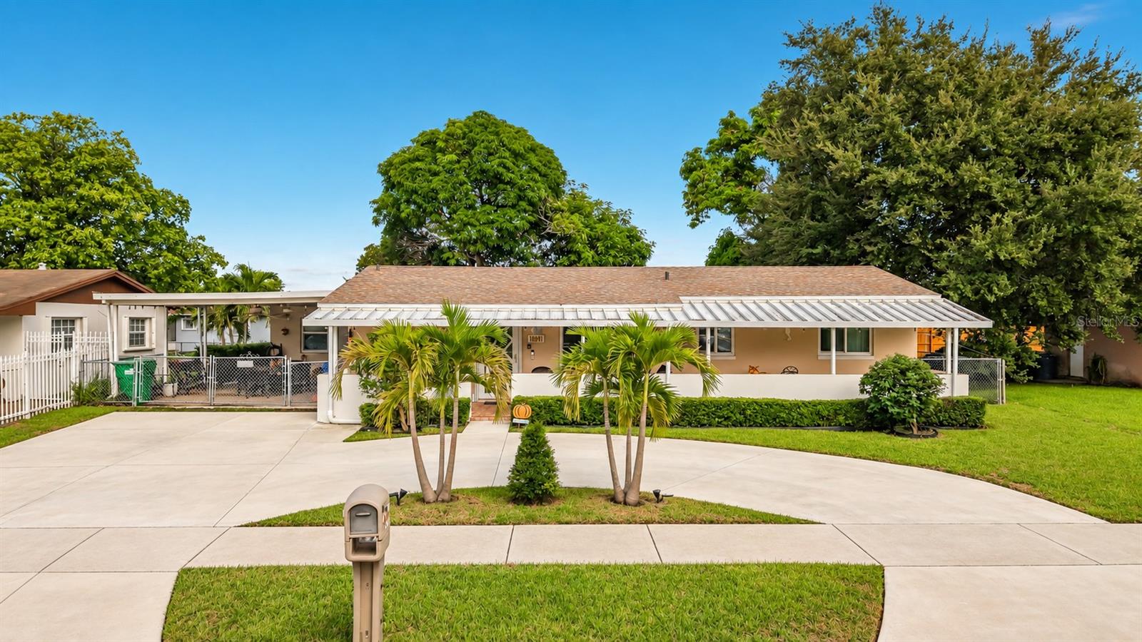RARE FIND IN MIAMI GARDENS! Offered for the first time by its original owners, this beautifully maintained 4-bedroom, 2-bath home reflects true pride of ownership, having been lovingly cared for by the same family throughout its life. Spacious, versatile and thoughtfully improved, this property offers an exceptional combination of comfortable everyday living, hurricane protection, expansive outdoor spaces and exciting possibilities for both homeowners and investment-minded buyers.Step inside to a bright and welcoming interior featuring two spacious living areas, a dedicated dining area and an open-concept flow designed for gathering and entertaining. At the heart of the home is a beautifully appointed kitchen showcasing rich wood cabinetry, abundant storage, attractive countertops, stainless-steel appliances, tile backsplash and a large island/peninsula with bar seating that opens naturally to the surrounding living space.One of the home's most distinctive features is the oversized guest room with its own private exterior entrance. Combined with the home's generous layout and multiple living spaces, this creates exciting possibilities for multigenerational living, extended family, private guest accommodations, an in-law-style setup, home office or future investment configuration.For buyers seeking income-producing possibilities, the home's size, private-entry arrangement and desirable Miami Gardens location may also provide an appealing starting point for exploring short-term rental/Airbnb or other rental opportunities, subject to applicable zoning, licensing, permitting and governmental requirements. The existing layout provides versatility that could mean less reconfiguration for a buyer seeking separate or more private living accommodations.Major improvements provide additional value and peace of mind. The home features a roof approximately one year old, with shingles on the main residence and attractive metal roofing over portions of the covered outdoor areas. Category 5-rated hurricane-impact windows and doors, including an impact front entry door and sliding glass door, along with transferable warranty documentation. A tankless water heater adds another desirable modern convenience.The outdoor living spaces are equally impressive. A beautiful covered front porch extends across much of the home, creating an inviting place to sit, relax and enjoy the South Florida lifestyle. A substantial covered side patio with ceiling fans provides even more room for BBQs, outdoor dining, celebrations and year-round entertaining. Additional backyard patio space, mature landscaping, a fenced yard and storage further enhance the property.Parking is another standout feature, with a large circular-style driveway and generous off-street parking, an especially attractive feature for larger households, frequent guests or buyers considering the property's investment potential.