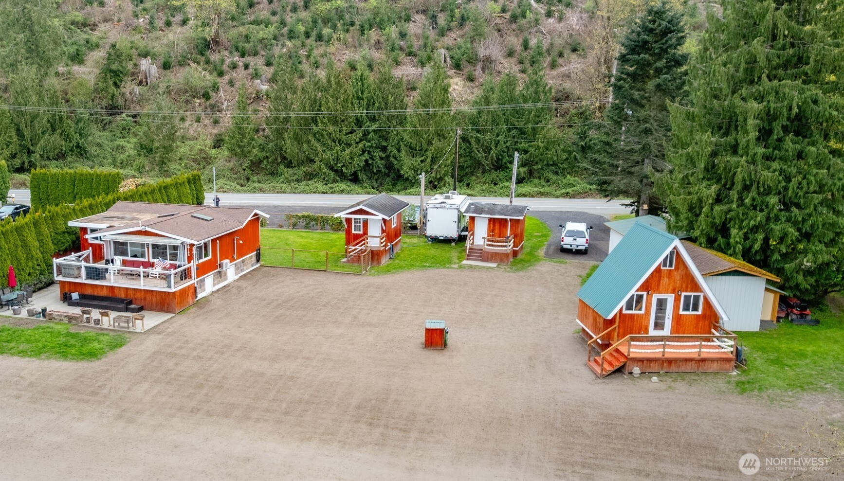 Enjoy the endless possibilities of living on your own riverfront retreat along the Skagit River.  Main home features a 1-bedroom, 3/4-bath open-concept layout with a beautifully updated kitchen, in-home laundry, mini-split heating and cooling, and a cozy pellet stove. Large windows fill the space with natural light and frame peaceful river views. A spacious deck and patio extend the living area outdoors—ideal for morning coffee, entertaining, or unwinding at the end of the day.    The property includes five additional buildings, highlighted by a charming A-frame cabin with loft bedroom, bathroom, and kitchenette—ideal for guests, extended stays, or potential rental income. The remaining buildings include a one-car garage, a versatile workshop, a separate building with bathroom, shower, and laundry, and two additional multi-use spaces suitable for studio use, storage, or expanded living potential. RV hookups and ample parking provide added convenience and functionality, making the property well-suited for full-time living, a private retreat, or investment use.