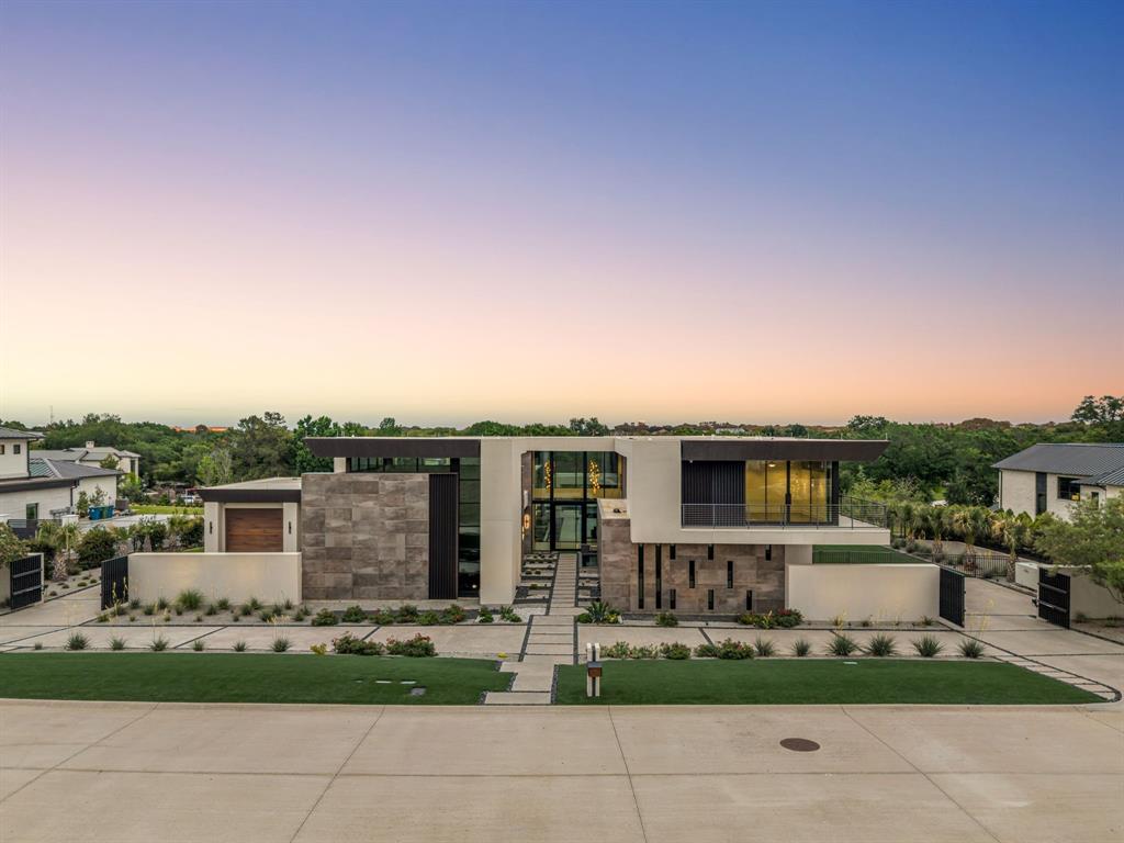 Set within the exclusive enclave of Quail Hollow, this ONE OF A KIND contemporary masterpiece draws inspiration from the visionary design of Blue Heron, known for blending innovation, craftsmanship and the natural environment. Bathed in natural light, the home features expansive walls of glass and oversized sliders that create seamless indoor-outdoor living. A dramatic great room anchors the home, flowing effortlessly into a show stopping kitchen with an oversized dual marble waterfall island, walnut cabinetry and Wolf and Sub-Zero appliances, ideal for both everyday living and grand entertaining. The thoughtfully designed floor plan offers 4 spacious bedrooms, along with a private gym with sauna that can easily serve as a sophisticated office or retreat. Refined finishes throughout, including Walker Zanger tile and rich marble surfaces add layers of modern elegance and texture. The primary suite is a true spa-like retreat, featuring dual vanities, a freestanding tub and a shower overlooking a private outdoor shower. A combined closet includes a separate storm shelter for added functionality and peace of mind. Outdoors oasis with two sleek pools and a separate terrace create a true resort-style setting, perfect for relaxing or entertaining. A rare opportunity to own a striking design-forward home in one of the area’s most sought-after communities in Westlake. Zoned to both Westlake Academy and CISD.