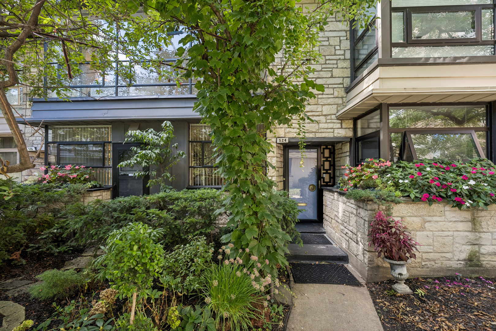 Super cool enormous Mid-Century townhouse that lives like a single family home. The expansive first floor features an open living/dining room with a wall of glass leading to a private patio/yard; a large kitchen w/small den/breakfast room; and a powder room. Upstairs are 3 bedrooms and two original 50's baths. Great lower level with huge recreation room and unbelievably large storage/utility room. Built solid out of steel and concrete, this townhome is in a beautiful courtyard in the heart of East Lakeview and Nettlehorst school district, within steps of Broadway shops and boutiques, the park and the lake.