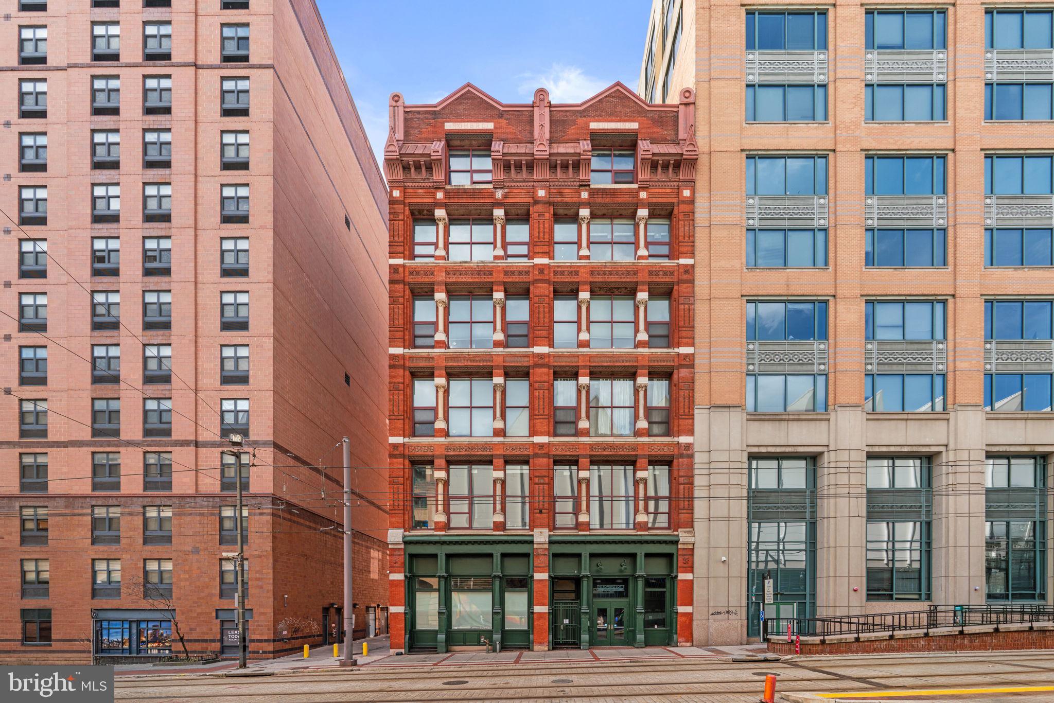 Welcome to 22 S Howard Street #R403, located in the historic Rombro Loft building in the heart of downtown Baltimore. Perfectly situated just steps from the University of Maryland campus, Oriole Park at Camden Yards, CFG Bank Arena, Ridgely’s Delight, and countless restaurants, shops, and entertainment options, this location offers the best of city living.This beautifully remodeled condo is truly one of a kind within the building. The home features soaring ceilings, large windows that fill the space with natural light, and durable waterproof luxury vinyl plank flooring (installed in Dec 2025) throughout. Stylish barn doors add unique character, while the thoughtfully designed layout offers two spacious bedrooms, each with walk-in closets featuring custom built-ins. The home was freshly painted in 2026, giving the space a clean and modern feel.The kitchen is equipped with stainless steel appliances and opens nicely to the living area, creating a comfortable space for everyday living or entertaining. Additional highlights include an in-unit washer and dryer.The building features a brand new elevator with smart access, adding modern convenience and improved accessibility for residents. While the building does not have its own parking garage, several garages surround the building and spaces are available for rent nearby. This distinctive condo offers charm, convenience, and unbeatable downtown access.