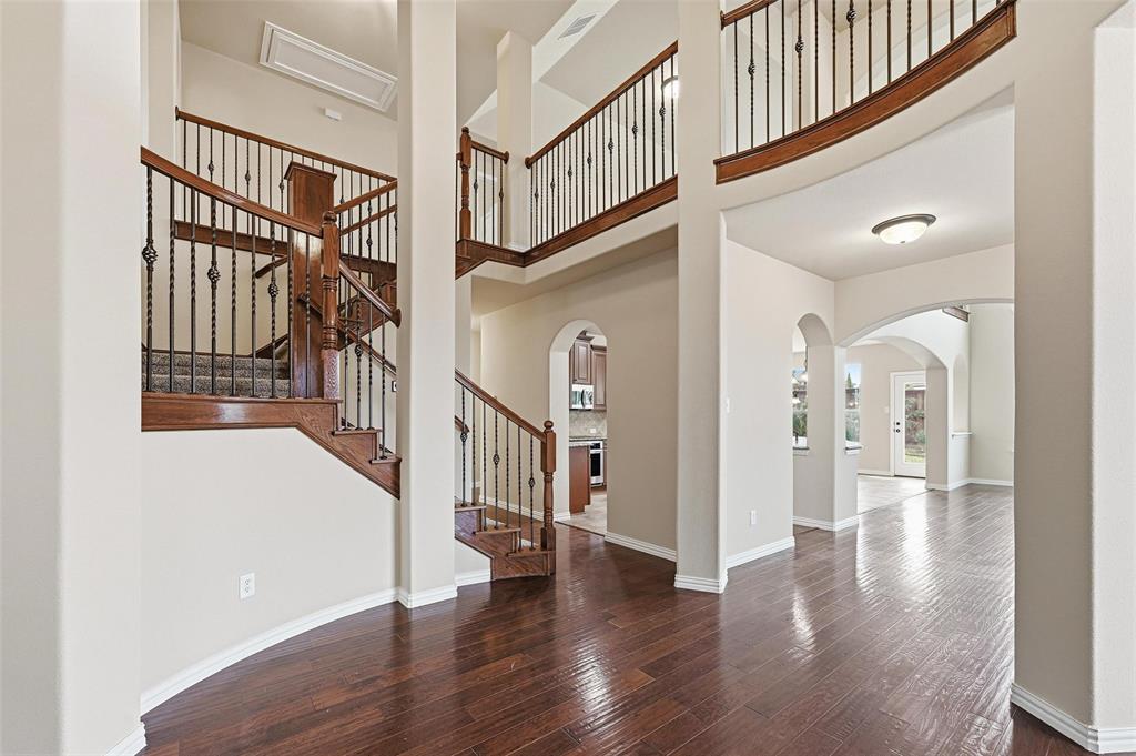 Step into this stunning Meritage home and fall in love from the moment you arrive. A grand entry begins at the spacious front porch that welcomes you into a dramatic rotunda that sets the tone for this thoughtfully designed and unique floorplan.Inside, you’ll find granite countertops, engineered hardwood floors, soaring two-story ceilings, a corner fireplace, and a striking open staircase with wrought iron spindles. Natural light fills the home, enhancing every carefully designed space.Situated on a desirable corner lot in a quiet cul-de-sac, this home offers something for everyone. The primary suite is tucked away in the back corner of the main floor, creating a peaceful retreat. The ensuite bath features a garden tub, walk-in shower, dual vanities, spacious walk-in closet, linen closet, and private water closet. The main floor also includes a dedicated study with French doors, formal living and dining areas, and an extended two-car garage equipped with an electric vehicle charger.Upstairs, the secondary bedrooms are anything but ordinary. One oversized bedroom connects to a Jack-and-Jill bath, another features a charming tower fit for a prince or princess, and a third showcases engineered hardwood floors. All bedrooms include walk-in closets and abundant natural light. A spacious flex room, originally designed as a media room, can easily serve as an additional bedroom, playroom, or homeschool space. The rooms are joined by a catwalk and large game room which carefully ties the space together.The professionally landscaped backyard with privacy fencing provides the perfect setting to create your own outdoor oasis, but being located in Inwood Hills, residents may enjoy the neighborhood pool and playground, plus nearby trails and quick access to Bonnie Wenk Park with fitness courts, dog parks, a fishing pond, sports fields, and more.This home blends character, comfort, and functionality in one exceptional package.