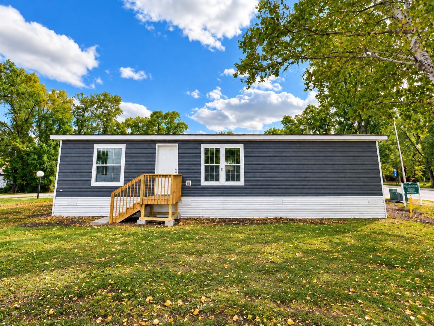 Brand-new Highland 28' × 48' double-wide manufactured home in Alexandria Estates! This 3-bedroom, 2- bath home offers a spacious, modern floor plan with approximately 1,280 sq. ft. of living space. The open living area provides plenty of room to relax or entertain, while the kitchen features brand-new appliances, generous cabinet space, and a large center island. The private primary suite includes its own en-suite bathroom, with two additional bedrooms and a second full bath providing plenty of flexibility. The striking dark exterior gives the home a distinctive, modern look with excellent curb appeal. Everything is brand new and move-in ready, including appliances, central air conditioning, landing, and skirting. Enjoy the benefits of a brand-new home without the repairs and updates that often come with an older property. Home is located on leased land in Alexandria Estates. Lot rent is $415/month. Community approval is required. Financing options may be available for qualified buyers.