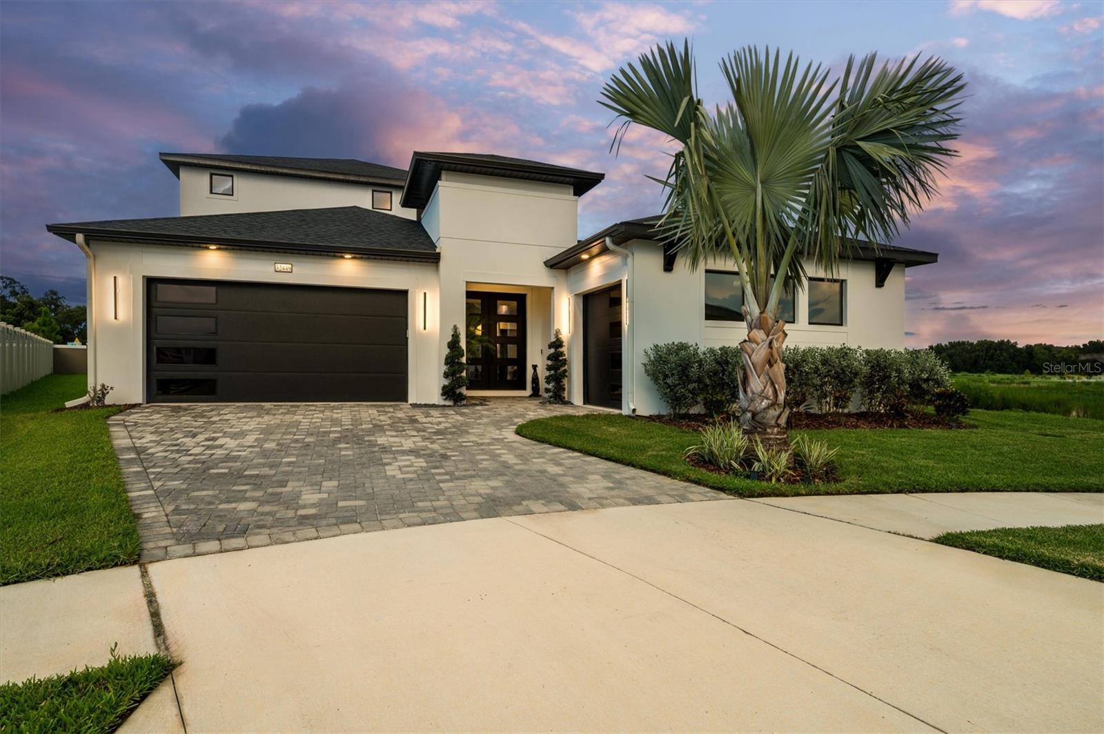Located in Mirada’s exclusive Eagles Cove—home to the 15-acre crystal-clear lagoon with sandy beaches, swim-up bar, VIP areas, and paddle-course fun—this 5BR/4.5BA Biscayne Homes *Osprey 3 (Modern elevation)* offers understated elegance and true privacy on one of the community’s largest end-of-cul-de-sac lots bordered by protected wetlands. A south-facing courtyard pool with spa, cabana bath, and cathedral gabled screen enclosure captures all-day sun and unobstructed nature views. Inside, refined architecture meets smart-home utility with 10–11’ ceilings, tray accents, upgraded LED lighting, and warm muted finishes. The gourmet kitchen blends seamlessly into living spaces with a 10’ quartz waterfall island, concealed appliance storage, and built-in Fisher Paykel refrigeration. Solid concrete construction, hurricane-rated bronze windows, full warranties, app-controlled security, and a three-car epoxy-floored garage with 8’ doors assure lasting quality. Mature palms, rain-sensing irrigation, and color-matched pavers complete this rare offering for buyers who appreciate lasting craftsmanship, privacy, and effortless access to a resort-style lifestyle.