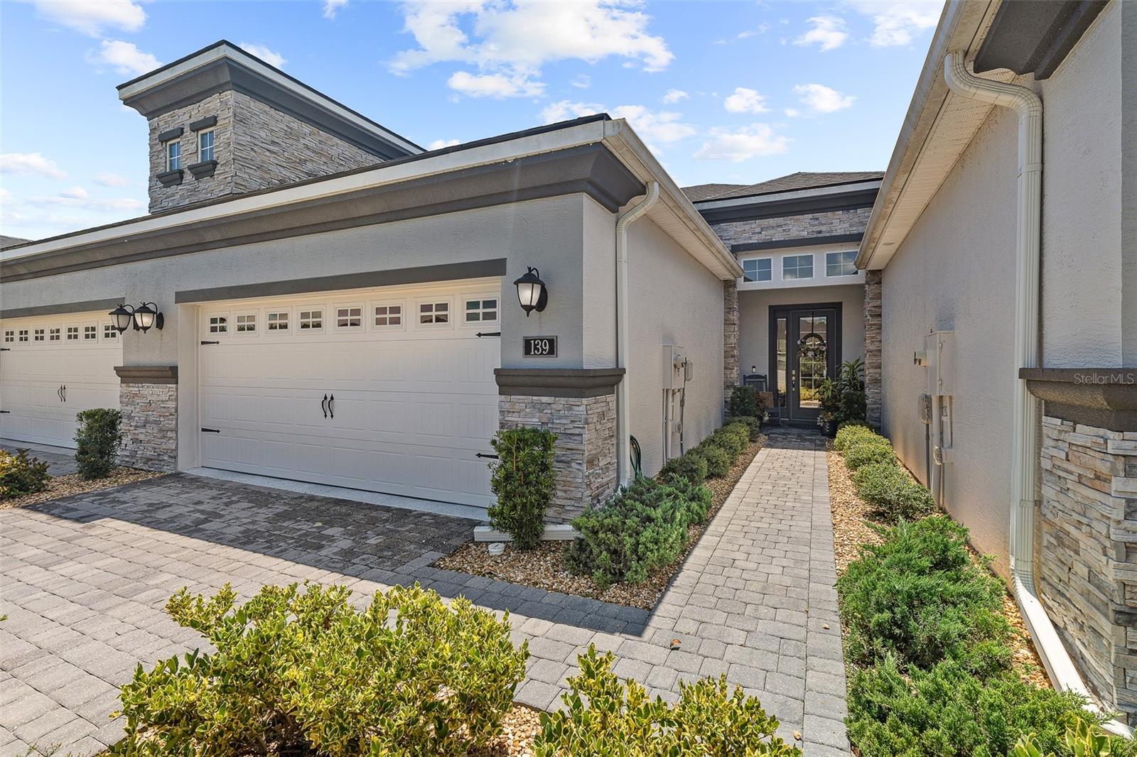 Townhome Perfection in Plantation Bay plus cruise the community in your own Golf Cart that comes with the Home! Step into this magazine-worthy townhome that truly shows like a model. Located in the coveted Plantation Bay Golf & Country Club, this home offers a maintenance-free lifestyle and even includes a golf cart so you can fully enjoy the community's resort-style amenities. The Kitchen is a chef's dream with mosaic tile backsplash, LG upgraded appliances (refrigerator features a cocktail round ice maker), 42-inch white soft-close dovetail cabinets, and elegant quartz countertops with a large island overlooking the dining area. The Dining Room features tile floors, a large window with plantation shutters, and a custom light fixture Flows into Family Room that is light and bright with tile floors, accent wallpaper wall, and sliders that open to the lanai for seamless indoor-outdoor living. Into your grand Master Suite you have a double door entry, large windows with plantation shutters, and a spacious walk-in closet. En-suite Master Bath features dual quartz sinks, tile walk-in shower, and private commode room. Guest Bedroom 2 completed with cozy carpet and plantation shutters. Bath 2 has chic wallpaper accent wall, quartz countertop, and tile tub/shower. Head Upstairs to the bonus room carpeted with a tray ceiling, plantation shutters, and a large storage closet. Bedroom 3 feels like a private suite with plantation shutters, abundant natural light, carpet, and a walk-in closet. En Suite Bath 3 has long quartz vanity, tile flooring, and a walk-in tile shower. Enjoy the Florida lifestyle with 1st floor screened lanai with long lake views. Additional Features include Private entry with glass front door, Lanai with large backyard and lake view to the side, laundry room with coastal accents and cabinet storage, 2-car garage with paver driveway, Easy access to the new West Gate entrance, 2 zone Ecobee thermostat. Cruise your included GOLF CART around located in GATED, golf cart friendly community of Plantation Bay. 45 holes of championship golf courses,9 tennis courts,10 pickleball courts, fitness center, spa, 2 pool with cabana bar and grill, walking trails, and new 30 million dollar stunning clubhouse and Prestwick Clubhouse. ASK LISTING AGENT ABOUT SPECIAL SIGNIFICANT DISCOUNT ON INITATION FEE AT THE CLUB!!! Move right in and start enjoying Plantation Bay's unmatched lifestyle in your magazine worthy townhome!