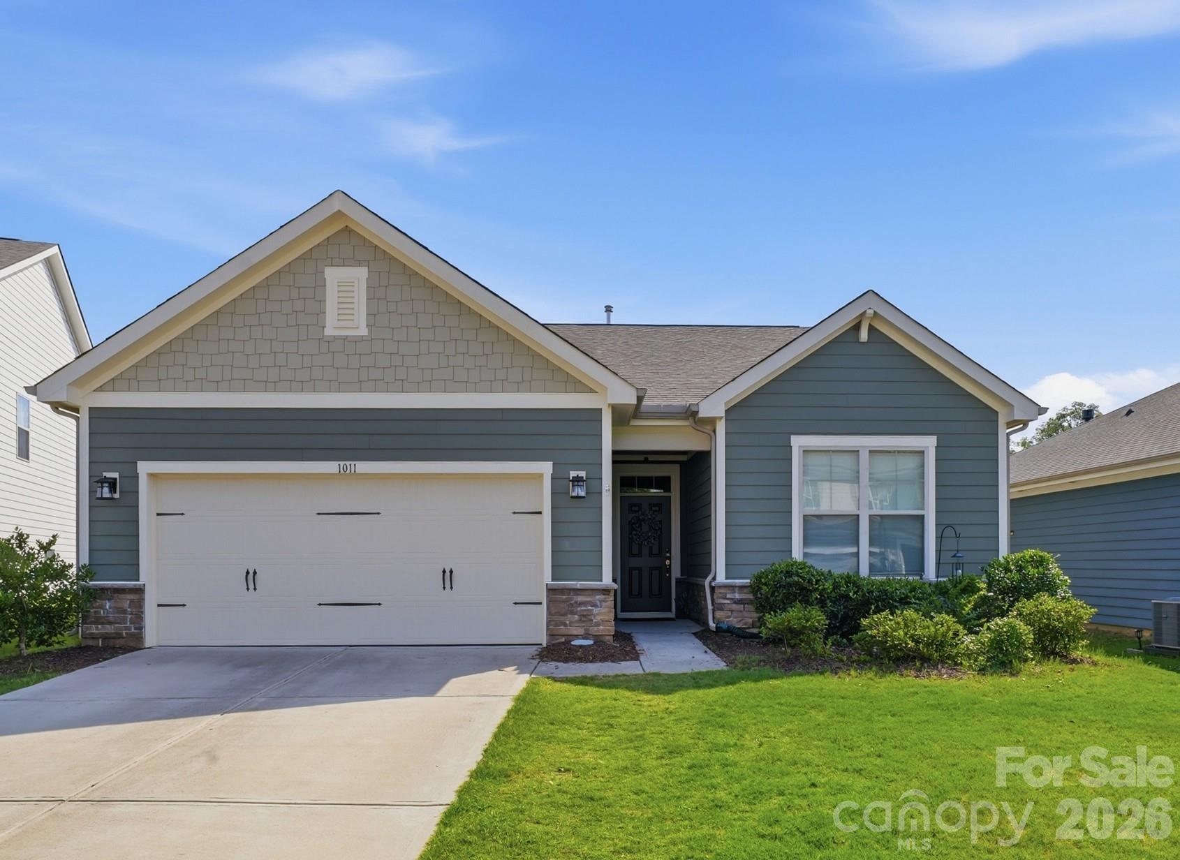 Here is that hard-to-find, charming one-floor home near Wesley Chapel and Sun Valley you have been seeking. This transitional ranch is ideal for those looking to avoid steps. You enter this lovely home from a zero-grade entrance under the canopy of a porch. There are also no steps into the garage or onto the patio. It is truly suited for buyers looking for true one-level living. From the spacious open floor plan to the thoughtfully planned flow of bedrooms, this home is a great find and amazing value. Two bedrooms in the front of the home share a spacious bathroom with elevated finishes on the stylish sink and vanity. A linen closet is located in the bathroom for more storage options. Both secondary bedrooms are spacious, one showcasing a queen bed and the other bedroom is staged as a combination bedroom/office. The foyer is wide and welcoming. Luxury Vinyl Planking (LVP) throughout most of the common spaces adds to the open and clean feeling of the space. A mud room/drop zone off the garage has been customized with built ins. A spacious laundry room is centrally located just off the drop zone. The kitchen boasts a nice gas cooktop for your home chef. The counters are a lovely stone finish. A large island with seating for breakfast or entertaining is included. The kitchen sink faces the great room, overlooking the island, inviting one to enjoy guests while preparing meals or cleaning up. There is an abundance of cabinetry  for storage, as well as a spacious pantry closet. The dining room and great room are both flooded with natural light from all of the windows at the rear. A cozy fireplace with a mantle for your holiday happenings adds to the charm. The electric fireplace is mounted to the wall and is operated by a remote. This space is clad in stylish shiplap, adding to the character of the fireplaces wall.  There are hookups above the mantle should you wish to mount your media in this area, as well. The home is rounded out with a lovely primary suite with separate vanities, an oversized walk-in closet with built ins, a large garden tub, separate shower and water closet. The rear of the home has fencing for your pets and a lovely patio for sipping your morning coffee or evening glass of wine. The lot extends beyond the fenced area. You are close to multiple grocery stores, the theatre at Sun Valley and a short drive to the quaint town of Waxhaw. This home is a delight. It is priced right and sure to fit the needs of many families.