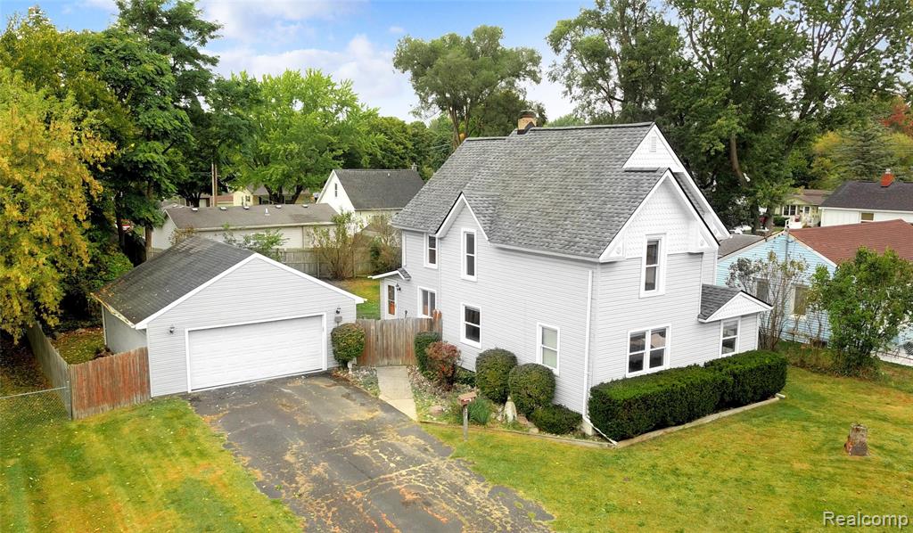 This character-filled home combines historic charm with modern updates, all within walking distance to vibrant downtown Fenton. Featuring hardwood floors throughout, a spacious kitchen, and a dedicated home office with French doors, it offers both style and functionality. Recent updates provide peace of mind, including remodeled bathrooms, a newer furnace and hot water heater (within the last 5 years), and a brand-new roof and gutters (2024). The private fenced backyard is perfect for relaxing or entertaining, and the oversized 2-car garage adds convenience. Additional highlights include spacious bedrooms, a clean/dry basement, and all appliances included—making this home truly move-in ready.