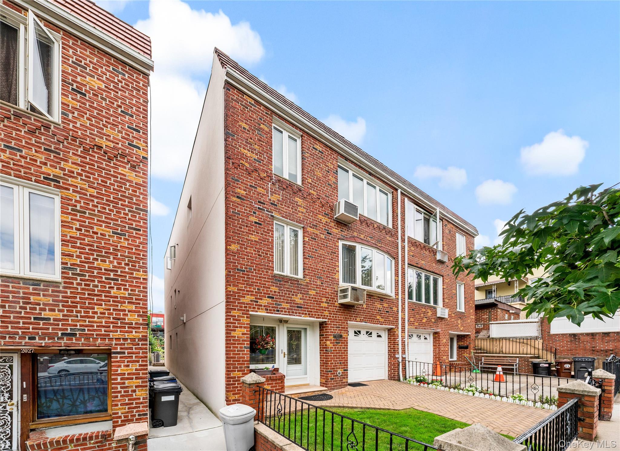 This well-maintained brick two-family home offers a unique combination of space, flexibility, and income potential. The top-floor apartment is currently rented, while the first floor and studio level will be delivered vacant, giving the next owner the opportunity to move right in or create a layout that works for their needs.What makes this home especially unique is the way the studio level has been connected to the first floor, creating a comfortable duplex-style residence with additional living space and direct access to the fully finished backyard. It’s a setup that feels more like a private home while still offering the benefits of a two-family property.The building itself has been very well cared for, with recent exterior improvements completed throughout. The front and backyard have both been upgraded with pavers, creating clean, low-maintenance outdoor spaces that are ideal for entertaining, relaxing, or enjoying time outside. The home has also been updated with split-unit heating and cooling for added comfort and efficiency.A private driveway and dedicated parking spot add even more value and convenience—something that is increasingly difficult to find. With a rented apartment providing income, a vacant duplex-style owner’s unit, private outdoor space, parking, and a solid brick exterior, this is a property that offers plenty of possibilities for its next owner.