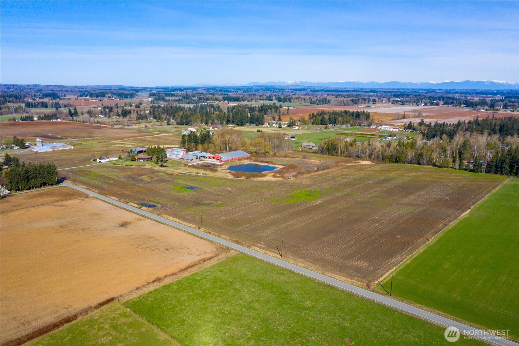 68-acre of fertile farmland with a Water Right Certificate and Water Right Applications, making it ideal for agricultural use such as growing blueberries, raspberries, or other crops. Previously a dairy farm would be a great place to raise beef cattle or other livestock. The property features two homes: a spacious 5-bedroom, 3.5-bath primary residence with 3,124 sq. ft. including a daylight basement, and a well-kept 3-bedroom, 2-bath manufactured home with a new roof. Both homes offer stunning, unobstructed views of Mt. Baker.  Over 57,500 sq. ft. of outbuildings, including a Loafing Barn, Commodity Shed, Hay Storage, Concrete Bunker Silo, and a Large Shop.  Loads of possibilities here!