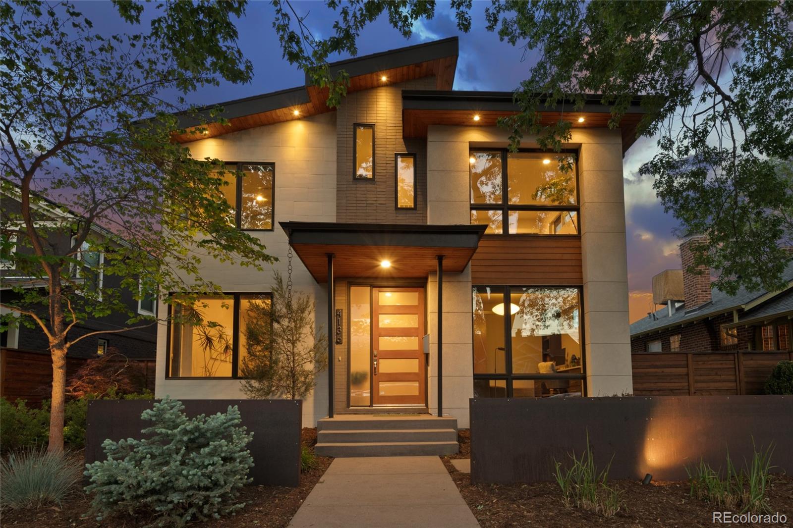 Introducing The Berkeley Haven—a thoughtfully designed custom-built home in one of Denver’s most cherished neighborhoods. Offered for the first time, this exceptional residence sits on two city lots and features immaculate landscaping and beautifully appointed living spaces. Soaring 10-foot ceilings and an open flow create an atmosphere that feels both expansive and inviting. The main level is designed for daily rhythms and entertaining, featuring a formal dining room, dedicated office, and open-concept kitchen and living area filled with warmth and light. The kitchen offers a pantry and designer breakfast nook with built-in seating. Two gas fireplaces add comfort and ambiance, while a powder room and spacious mudroom enhance convenience. Upstairs, the primary suite features generous walk-in closets and a dual-head shower. Two additional bedrooms, a full bath, and laundry room complete the level. A versatile loft opens to a covered east-facing balcony—perfect for enjoying Colorado sunrises and evening skies. The finished lower level includes two additional bedrooms, a 3/4 bath, and a large gathering space ideal for recreation, relaxation, or hosting guests. Outdoors, The Berkeley Haven truly shines with an expansive yard, covered patio, curated landscaping, raised irrigated garden beds, built-in fire pit, and tranquil fountain—creating a setting designed for both peaceful mornings and lively gatherings. With three and a half garages, the property offers rare flexibility for storage, hobbies, and Colorado adventure. Situated on a quiet, tree-lined street in the heart of Berkeley, the home is ideally located between Highlands Square and Tennyson Street, with easy access to Rocky Mountain Lake and Berkeley Park. Enjoy peaceful neighborhood living with close proximity to Denver’s beloved dining, boutiques, parks, and community events. The Berkeley Haven is more than a home—it’s a place designed for meaningful connection and exceptional hospitality.