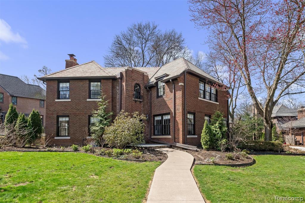 Beautifully maintained and thoughtfully updated, this historic 1924 Ives Woods home seamlessly blends timeless character with elevated modern living. The entry level showcases original hardwood floors and exquisite architectural details, including a formal dining room with an original ceiling rosette and plaster moldings, and a sun-filled living room centered around a striking fireplace adorned with original English tiles. The chef’s kitchen, designed by Forward Design Build (2018), is a true showpiece—featuring a La Cornue range, Sub-Zero refrigerator, Bosch dishwasher, custom Das Holz Haus cabinetry, and a stunning combination of Via Lattea granite counters and a Statuario marble island. Upstairs, the luxurious primary suite offers a spacious walk-in closet and a beautifully appointed bath with two sinks and a euro glass shower. A second bedroom includes its own private full bath, while the third bedroom opens to a versatile bonus space—ideal as a fourth bedroom, home office, or art studio. A third full bath in the hall completes the upper level. The lower level features a comfortable, carpeted family room with built-in shelving, a dedicated laundry area, and abundant storage. Outside, the professionally landscaped grounds provide a serene outdoor retreat with a bluestone patio and fully fenced backyard—perfect for relaxing or entertaining. Extensive recent updates include a new driveway (2025), new fence (2023), whole-house generator (2023), added upstairs laundry (2023), new AC (2023), new water heater (2024), and new basement washer and dryer (2026). Ideally located less than a mile from Burns Park, the University of Michigan campus, and U of M Hospital, this exceptional home offers historic charm, modern luxury, and an unbeatable location. Truly stunning!