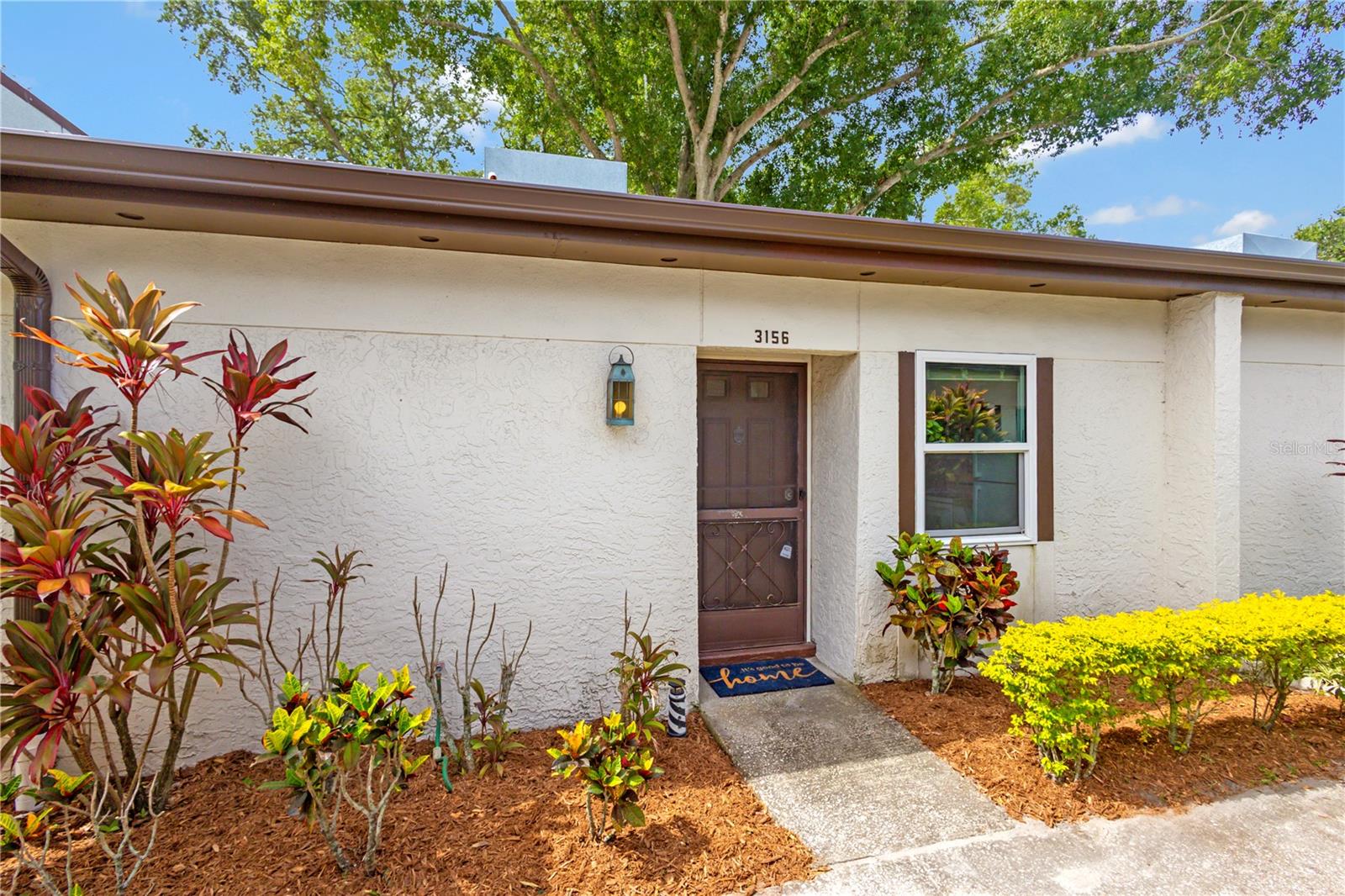 Virtually Staged. Relax and unwind and begin living your carefree lifestyle in this 1-Bed 1 Bath Villa style condo located in Highland Lakes Mission Grove Condo Community.  Enjoy peaceful mornings and relaxing evenings in the enclosed lanai overlooking a beautifully landscaped green space. Convenience is built in with a private carport to park your car or golf cart and an attached storage closet, providing extra space for bikes, beach gear, tools, and more. Monthly fees include unlimited golf, two clubhouses each with their own swimming pool, tennis courts, shuffleboard, access to scenic Lake Tarpon, and countless social events, activities, and clubs designed to fit every interest and lifestyle. Updates: 2022 PGT Hurricane Impact Custom Windows "Low E" throughout the unit, Handicap Bars installed in the bathroom shower, Microwave 2021, Top Mount Fridge 2022, and HVAC replaced 11/2025. This corner villa offers the perfect blend of comfort, community, and low maintenance living whether you are looking to downsize, an investment property, or a seasonal vacation home.  This community is sure to make you feel right at home.  High and Dry/ NON-Evacuation Zone/ X Flood Zone. Conveniently located close to shopping centers, Gulf Beaches, restaurants, and approximately 16 miles from Tampa International Airport making travel easy for seasonal residents and visitors.Schedule your showing today!!! No carpet here, Move-in Ready, and priced to sell. Begin living the Active Adult Lifestyle you deserve!!