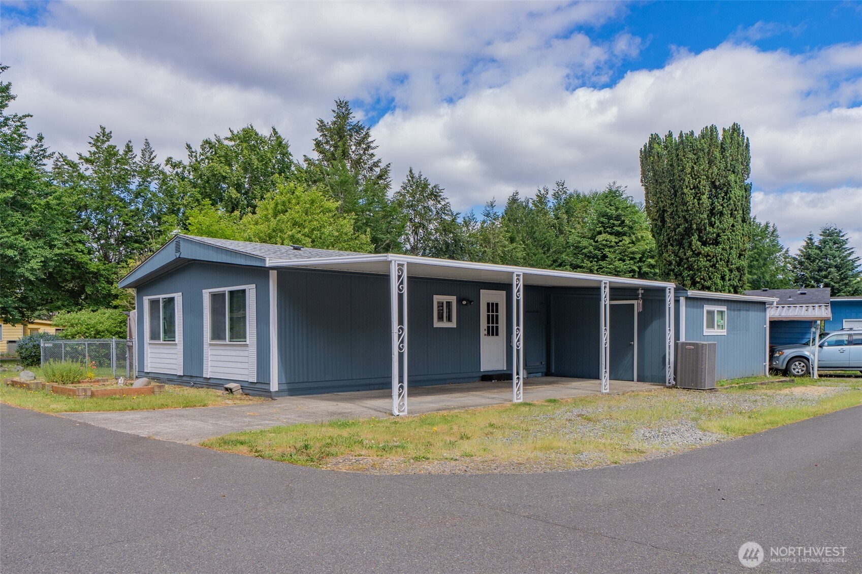 Find your perfect blend of quiet living and convenience in this charming double-wide manufactured home situated on a spacious corner lot within a vibrant, all-ages community. Bathed in natural light you'll walk into a spacious living area featuring updated flooring, fresh interior and exterior paint, updated appliances, and a newer roof above. This home is an affordable canvas ready for your personal love and vision. Enjoy the privacy of a fully fenced yard, covered parking, and a large shed ideal for extra storage or hobbies, all located just moments from shopping, parks and dining. With a monthly space rent of $1,199 and a community known for fun and friendly events, this cute and convenient property is the ideal opportunity to own a home close to all the fun and services you need.