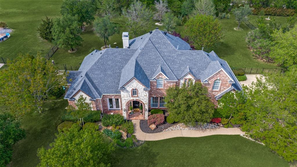 A remarkable opportunity awaits! With a significant price improvement, this custom home on a sprawling 1.28-acre lot is now positioned at an exceptional value. Welcome to Gentle Creek Estates, where luxury meets golf lifestyle on a premier 1.28-acre lot in the heart of Prosper. This stunning custom home has been thoughtfully renovated and is ready to impress, offering 4 spacious bedrooms, 4 baths, an executive office with French doors, an elegant formal living room, and two dining areas designed for both entertaining and everyday living. Every detail has been carefully curated. Custom finishes and new lighting set a sophisticated tone throughout, while the beautifully updated kitchen takes center stage with crisp white cabinetry, new countertops, a farmhouse sink, a large center island, gas cooktop, and double ovens, all open to the family room for effortless entertaining. Soaring floor-to-ceiling windows, bar area and a cozy fireplace make the family room a warm, inviting space bathed in natural light. Retreat to the primary suite, a true sanctuary featuring private patio access, a spa-inspired bath with quartz countertops, and a generous walk-in closet that offers a serene escape from the everyday. Upstairs, three large secondary bedrooms and a massive game room provide ample space for everyone. Step outside to your backyard oasis, where lush landscaping, a covered patio, and an expansive yard create the perfect setting for outdoor living and entertaining. A 3-car garage rounds out this exceptional property, and the home is zoned to Prosper ISD with attendance to Walnut Grove High School. Opportunities like this on 1.34 acres in Gentle Creek Estates are rare, don't miss yours!