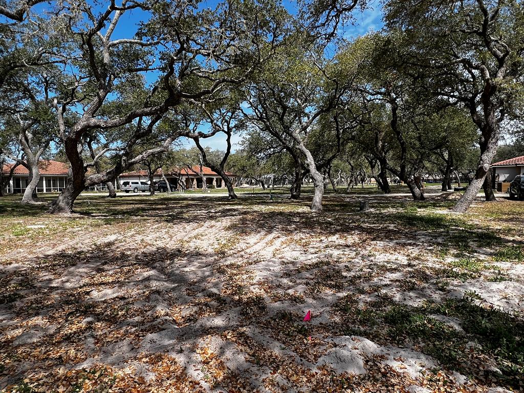 See what is behind the gate at Royal Oaks! The name says it all with majestic oak trees blanketing each lot. Only limited to one's imagination, this 6140 sq.ft. lot is ready for your custom build to commence. This exclusive gated waterfront community provides the pleasure of privacy with the storybook elegantly curved walls that line the front and back of the community. Entering the neighborhood over the cobble stone road from Fulton Beach Rd, past the guardhouse, immediately a rush of calm takes over. This therapeutic setting will be your place of peace and easy living. Take a minute to stroll the lighted walk paths to the gorgeous pool or gather under the gazebo. Invite friends for an evening around the fire pit to talk about the day on the boat while sipping on your favorite beverage. Need a little putting practice? Pick from the two greens overlooking the bay. Morning, afternoon or evening, the lighted fishing pier is the perfect place to drop a line.