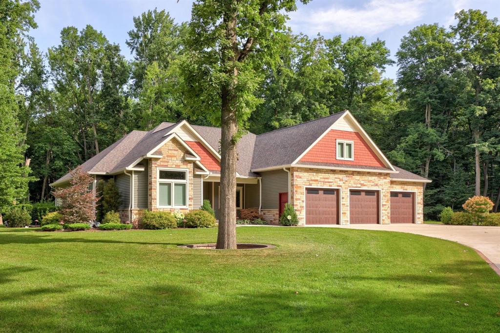 Nestled within 20 secluded, wooded acres, this extraordinary estate offers a rare blend of natural beauty, refined craftsmanship, and serene privacy. A long, gated driveway winds through the trees, leading to a peaceful clearing where this ranch-style residence with over 4,800 square feet of finished living space commands attention. Built to the highest standards by premier builder Jason Cook, the home is a true showcase of exceptional design and detail, surrounded by nature's splendor and enhanced by an Amish-built pavilion with a stone fireplace, a custom chic reading shed, and an impressive 4,160-square-foot custom framed outbuilding. Upon arrival, you're welcomed by a grand covered porch and an inviting foyer that opens to an airy, open-concept layout highlighting a beamed-ceiling great room and a tranquil library or den with French doors, a stone fireplace, and private outdoor access. The dream kitchen impresses with a large granite island and farmhouse sink, custom cabinetry and backsplash, a pot filler, vented range hood, coffee station, and walk-in pantry. The dining area seamlessly blends indoor and outdoor living, opening to a screened-in porch perfect for relaxing or entertaining. An executive-style office with built-ins, shelving, uplighting, and leathered granite surfaces doubles as a main-floor guest room. The primary ensuite is a retreat of its own, featuring custom trim, dual closets, built-in speakers, and a luxurious five-piece bath with heated flooring and toe-kick lighting. The lower level expands your living space with a 3rd bedroom and full bath also with heated flooring, a kitchen and bar area, large recreation area, professional craft room, and an impressive theatre room complete with seven reclining chairs, authentic theater carpet, and lighting and superior sound. Highlighted details include a drop station and coat closet designed for a future elevator, a first-floor laundry room with a doggie shower and sorting drawers, and an oversized three-car garage. Above the garage, a well-appoint