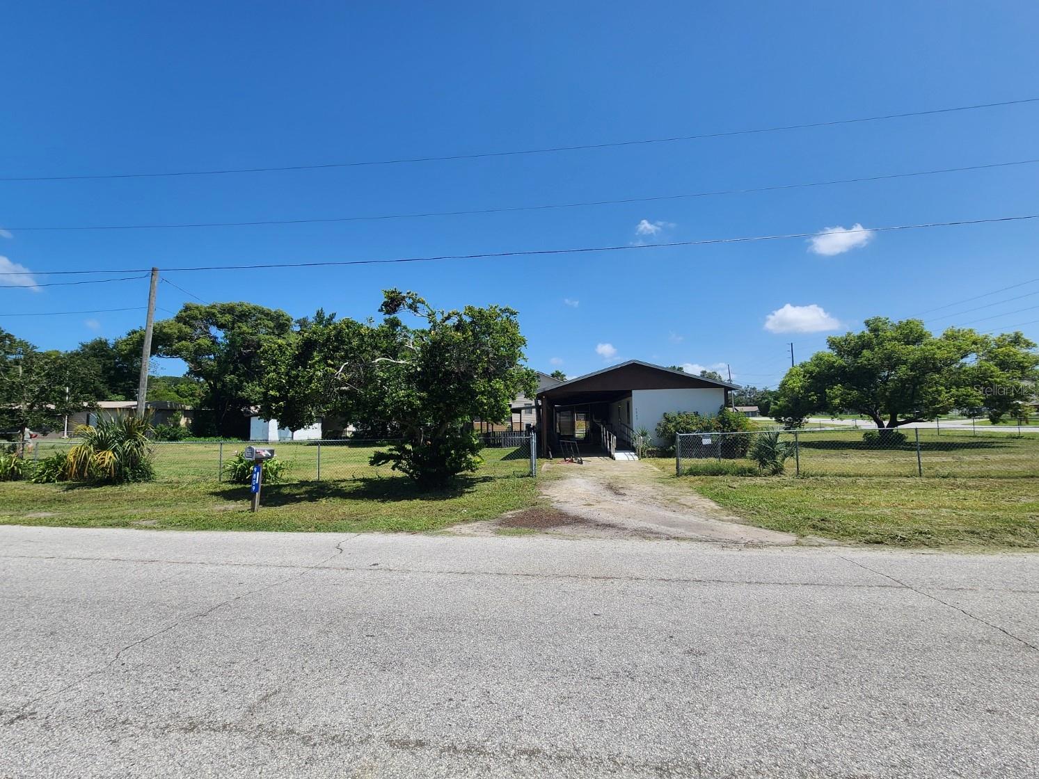 Affordable Mobile on Fenced Corner Lot – Tons of Potential!

Welcome to 9809 Fred Street, a 2-bedroom, 1-bath mobile home situated on a generous, fenced corner lot in Hudson with no HOA. Whether you're an investor or handy buyer, this property offers a great opportunity to build equity with your own improvements.

Inside, you’ll find updated vinyl plank flooring throughout, an open living/dining space with sliding glass doors leading to a screened patio, and a charming kitchen featuring tile countertops, double sink, and a stainless steel range. Both bedrooms include ceiling fans and natural light, and the full bath features a tub/shower combo with washer and dryer hookups conveniently located inside. A hall closet provides bonus storage space.

Outside, enjoy the covered carport with handicap-accessible ramp, an additional shed, screen room, and a chicken coop — all sitting on a flat lot with mature trees and space to expand or customize.

The home needs repairs, including the roof over — and is priced accordingly. Seller is motivated and willing to negotiate a credit toward roofing costs.

Listing Agent is Related to Seller.