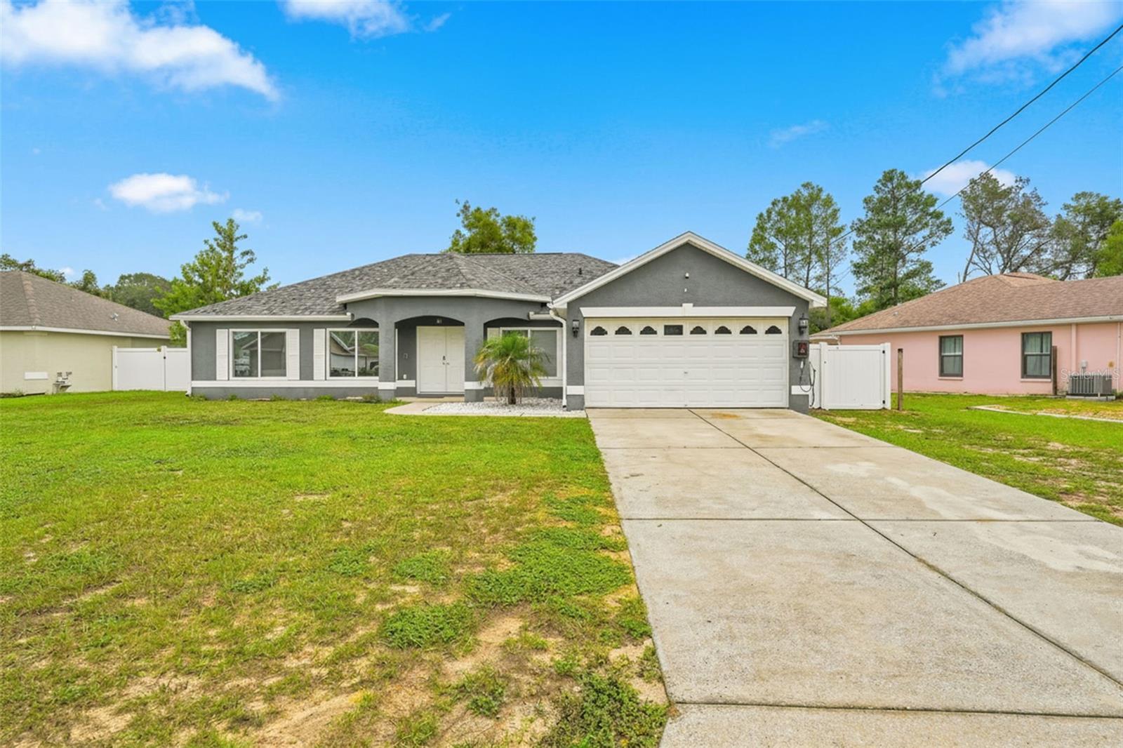 Beautifully updated 3/2, 1,480 sqft home featuring a renovated modern kitchen, vinyl plank flooring, and an open-concept living area filled with natural light. Kitchen features a large center island with stone counters, newer stainless steel appliances; including a wine cooler. Kitchen also offers a double-pantry. Two large living spaces. Additional flex/bonus room off the kitchen is perfect for a den, nursery or office space. Enjoy peace of mind with a new roof (2025) and new septic drain field (2022). Inside laundry room. Walk-in closets in master. French doors open to a spacious, fully fenced yard—perfect for pets, play, and outdoor living. Move-in ready with stylish finishes, a two-car garage, and a welcoming layout in a convenient Spring Hill location.
