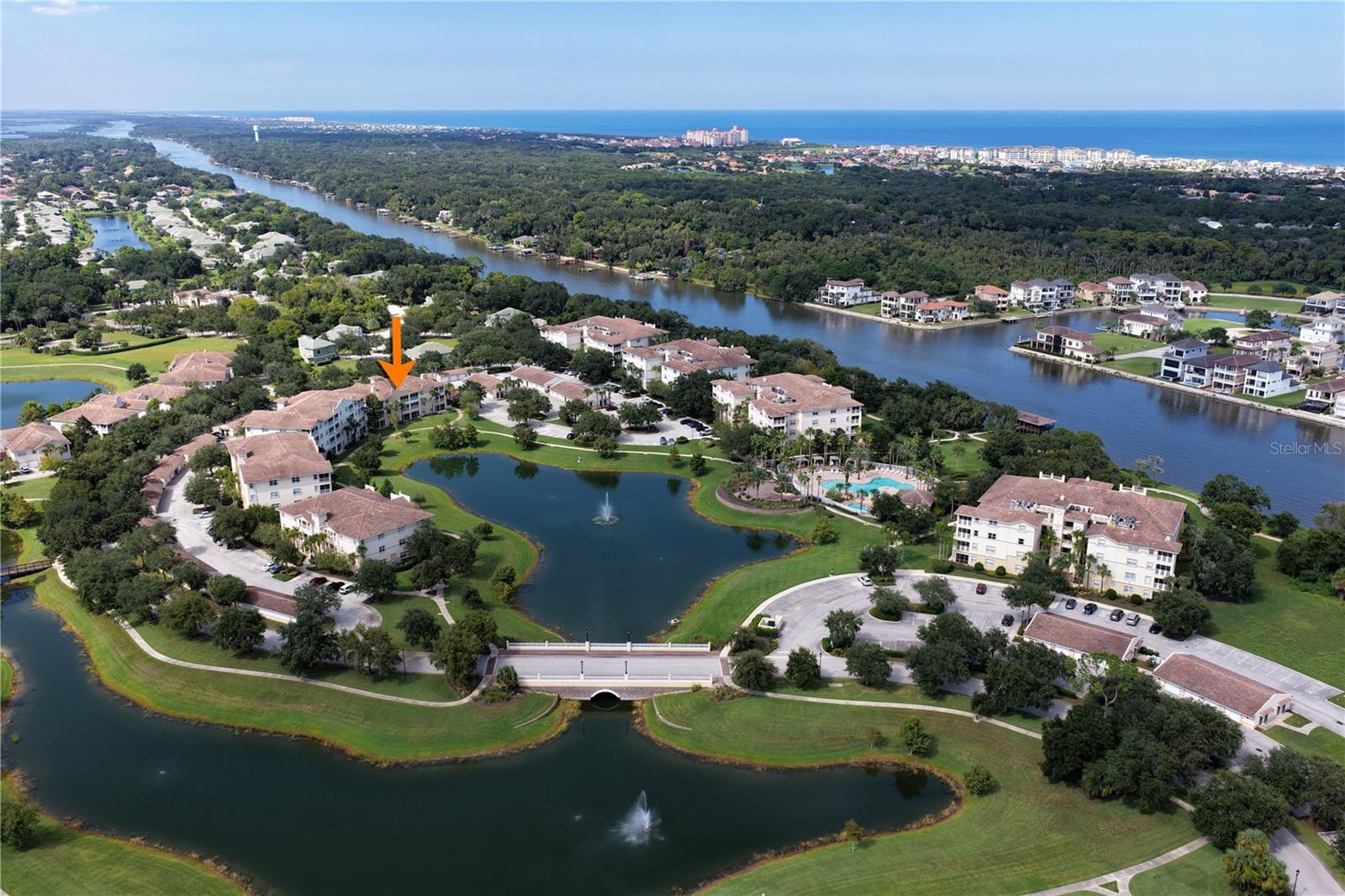 Meet one of the true “unicorns” of Tidelands, a rare top-floor end-corner residence with vaulted ceilings, additional side windows, beautiful lake views and the highly coveted GARAGE. This is the combination Tidelands buyers wait for, and this one has been thoughtfully renovated and beautifully styled from the moment you enter. Step inside through a true entry vestibule offering a welcoming sitting area and convenient niche, the perfect place to drop your keys, remove your shoes or set down your bags before entering the main living space. From here, the open floor plan draws you in with soothing sky-blue walls, crisp white trim, upgraded lighting and an abundance of natural light created by the end-unit location. To the right is the private guest wing with guest bath, while directly ahead a modern breakfast nook sits adjacent to the open kitchen, which offers two convenient points of entry for an easy, flowing layout. And then comes the WOW moment. The renovated kitchen is striking, with upgraded gray-blue cabinetry, crisp quartz countertops featuring subtle light-blue veining and a softly varied white and off-white flagstone backsplash. Downlighting combined with customizable accent uplighting adds another layer of sophistication and allows you to change the mood of the space from day to evening. Continue into the dining and living areas and the top-floor view of Tidelands’ main lake quickly steals the show. Palm trees frame the sparkling fountain while adding a sense of privacy, and at night the illuminated fountain creates an entirely different atmosphere. A lush tree to the right provides beautiful greenery during much of the year, then loses its leaves in winter to reveal an even broader seasonal view. Triple sliding glass doors open the living room to a spacious covered screened lanai with plenty of room for lounge seating, dining or your own outdoor retreat. Sit for a while, enjoy the breeze and take in the lake and fountain views, this is Florida living exactly as it should feel. The desirable split-bedroom floor plan continues with an exceptionally spacious Primary Suite featuring its own lakefront window and direct access to the screened lanai. There is ample room not only for a king-size bed, but also a separate sitting area, reading space, lounge or home office. Luxury vinyl flooring extends throughout the main areas of the residence, while the guest bedrooms feature upgraded cushioned Berber carpet. Vaulted ceilings and the additional windows available only with an end-unit location further enhance the bright, open feeling of this special top-floor home. Modern furnishings complement the renovated interior and enhance the clean, contemporary feel of the residence. And then there is the Tidelands lifestyle. This gated Intracoastal community offers underground utilities, onsite management and resort-style amenities, including two pools, a year-round heated clubhouse pool and an Intracoastal-front pool with cabanas and heated spas. Enjoy miles of walking paths, more than a mile along the Intracoastal, a fishing pier, waterfront pavilion, fitness center, tennis, pickleball, basketball, billiards, table tennis and foosball. Here, you are not simply buying a condo, you are stepping into a lifestyle of water views, sunshine, recreation and relaxation. Top floor, end corner, vaulted ceilings, renovated interior, lake and fountain views, and a GARAGE. One of the unicorns of Tidelands has arrived!