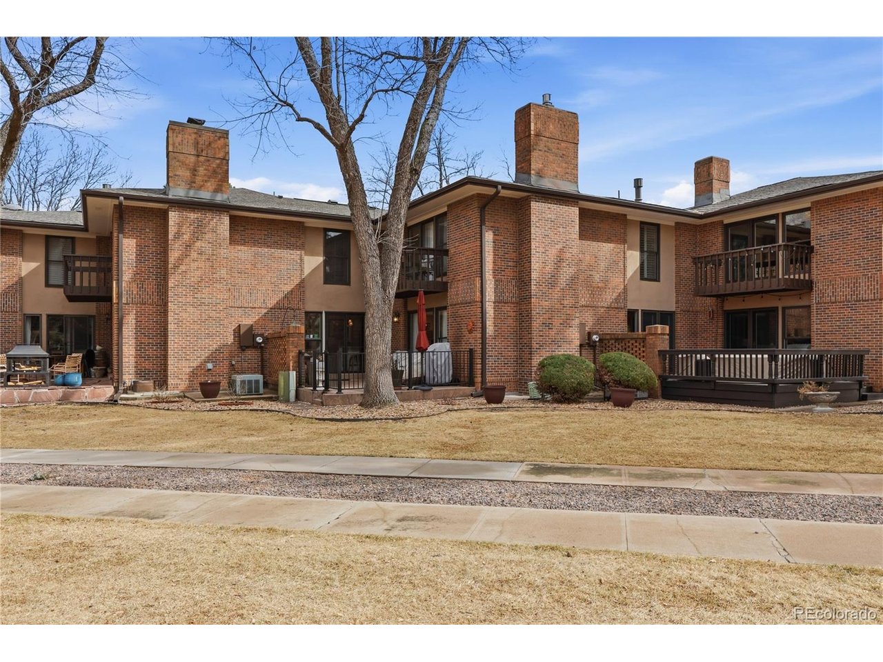 This outstanding condo perfectly combines luxury, comfort, and privacy in a tranquil setting located in the highly sought after Pinehurst Country Club area. The welcoming courtyard introduces you to this fabulous, remodeled home. The open, main living area has an abundance of natural light and warmth. Relax in the cozy sitting area with a brick, gas log fireplace that offers effortless access to the peaceful patio overlooking the green belt with a view of the golf course. The kitchen is a standout, featuring granite countertops, stainless steel appliances, new cabinetry, pantry, and built-in buffet (peninsula) for casual meals or grand soirees. A main floor office has built-ins and a closet. The spacious primary bedroom offers an en suite bathroom, walk-in closet and opens to a private deck. There are two more bedrooms and a laundry shoot off the full bath. The finished basement boasts a large family room, bonus room for crafts or work-out equipment, a non-conforming bedroom, full bath, laundry room with utility sink and storage. High-end finishes and upgrades: crown molding, wide baseboards, wide plank wood floors, lighting, new carpet, gorgeous staircase, new entry door and kitchen sliding glass door enhance this meticulously maintained condo. The front courtyard and back patio are gated. The HOA is financially sound, professionally managed and provides grounds and exterior building maintenance, water inside and out, snow removal, trash, recycling ... Situated in a central location to highways, downtown, mountains. Mullen, Colorado Academy, and Denver Christian are minutes away. This is a rare opportunity to enjoy a carefree lifestyle in this serene and beautiful neighborhood.