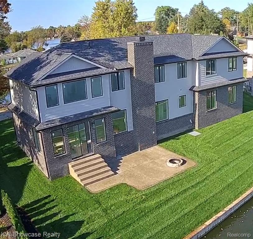 Welcome to Luxurious All-Sports Lakefront Living With an Up-North Feel – 100’ of Prime Pontiac Lake Frontage!Brand-new 2025 custom-built home on the 640-acre all-sports Pontiac Lake. Pull your boat right up to the seawall and tie off – no dock required.•  3,400 finished sq ft•  3 bedrooms | 2.5 bathrooms•  Dramatic open floor plan with 9’ ceilings and 8’ tall solid-core doors•  Great room anchored by a soaring floor-to-ceiling stone fireplace with unobstructed lake views•  Gourmet kitchen featuring a stunning arched stone hood vent, custom cabinetry, huge granite & stone island with seating for 8, walk-in pantry•  Massive second-floor entertainment/media room•  Lakeside primary suite plus two additional bedrooms – every bedroom enjoys gorgeous water views•  Huge exposed-aggregate patio with built-in fire pit stretching toward the lake•  Zoned HVAC, whole-house water filtration, lawn irrigation system•  All appliances included (stove, refrigerator, drawer microwave, dishwasher, washer & dryer)Just minutes from the 3,800-acre Pontiac Lake Recreation Area boasting southeast Michigan’s longest beach, one of the top-rated mountain bike trails in the country, equestrian trails, hiking, and camping.Kayak at dawn, wakeboard or jet-ski all day, then unwind with slow sunset cruises and lakeside bonfires.                          This is lakefront living at its absolute finest.Life is simply better at the lake