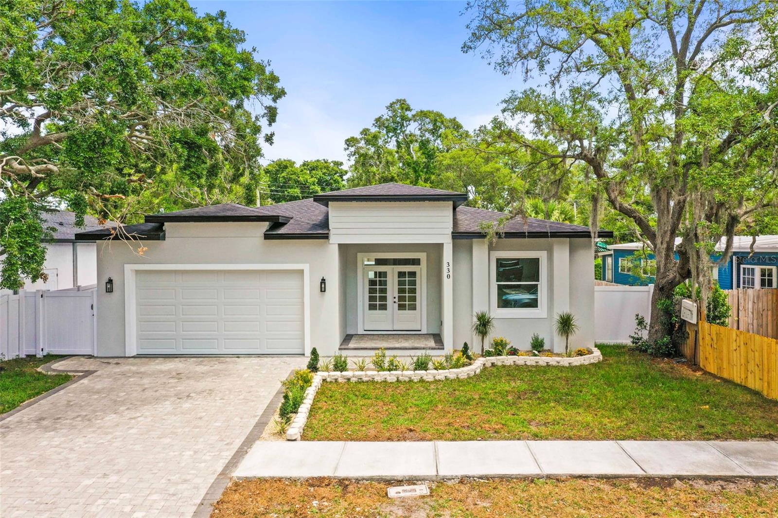 Welcome to this stunning new construction home perfectly located in one of Dunedin’s most desirable areas, offering the ideal blend of luxury, convenience, and the ultimate Florida lifestyle. From the moment you arrive, you’ll be impressed by the beautiful curb appeal featuring a paver patio, lush tropical landscaping, an inviting covered front porch, and striking double front doors that open into a grand foyer entrance.Step inside to an impressive open-concept floor plan filled with natural light, soaring ceilings, and upscale modern finishes throughout. The spacious living room showcases a custom built-in shelving feature wall, creating the perfect centerpiece for entertaining or relaxing. The gourmet kitchen is truly a showstopper with quartz countertops, custom cabinetry, upgraded stainless appliances, designer finishes, and an oversized island ideal for hosting family and friends.The stunning primary suite offers a luxurious private retreat with plenty of space to unwind. The spa-inspired primary bathroom features beautiful double vanities, designer finishes, and a gorgeous oversized walk-in shower that creates a true resort-style feel. The primary suite also includes a spacious walk-in closet with custom closet systems designed for both style and functionality, offering exceptional storage and organization. Additional custom closets throughout the home provide plenty of storage space while maintaining the clean modern aesthetic of the property.Built for both style and peace of mind, this home features solid block construction along with hurricane impact windows and doors throughout. The oversized two-car garage includes an epoxy-finished floor, while the expansive backyard offers endless possibilities with plenty of room to create your dream outdoor oasis. There is ample space for a custom pool, outdoor kitchen, and a large screened-in lanai, giving you the opportunity to design the ultimate Florida backyard retreat perfect for entertaining, relaxing, and enjoying year-round outdoor living.What truly sets this property apart is the incredible location. Hop on your golf cart or bike and be in Downtown Dunedin within minutes where you can enjoy award-winning restaurants, breweries, rooftop bars, boutique shopping, waterfront parks, festivals, live music, and the famous Pinellas Trail. You are also only about five minutes from Countryside Mall for convenient shopping and dining, and approximately 7–10 minutes from Honeymoon Island State Park where you can enjoy some of Florida’s most beautiful beaches, kayaking, boating, fishing, and breathtaking sunsets.Located outside the City of Dunedin limits, this property offers added flexibility with potential short-term rental opportunities, making it an incredible option for a primary residence, vacation home, or income-producing investment property.This is more than just a home — it’s a chance to live the highly sought-after Dunedin lifestyle in a beautifully built modern new construction home. Schedule your private showing today.