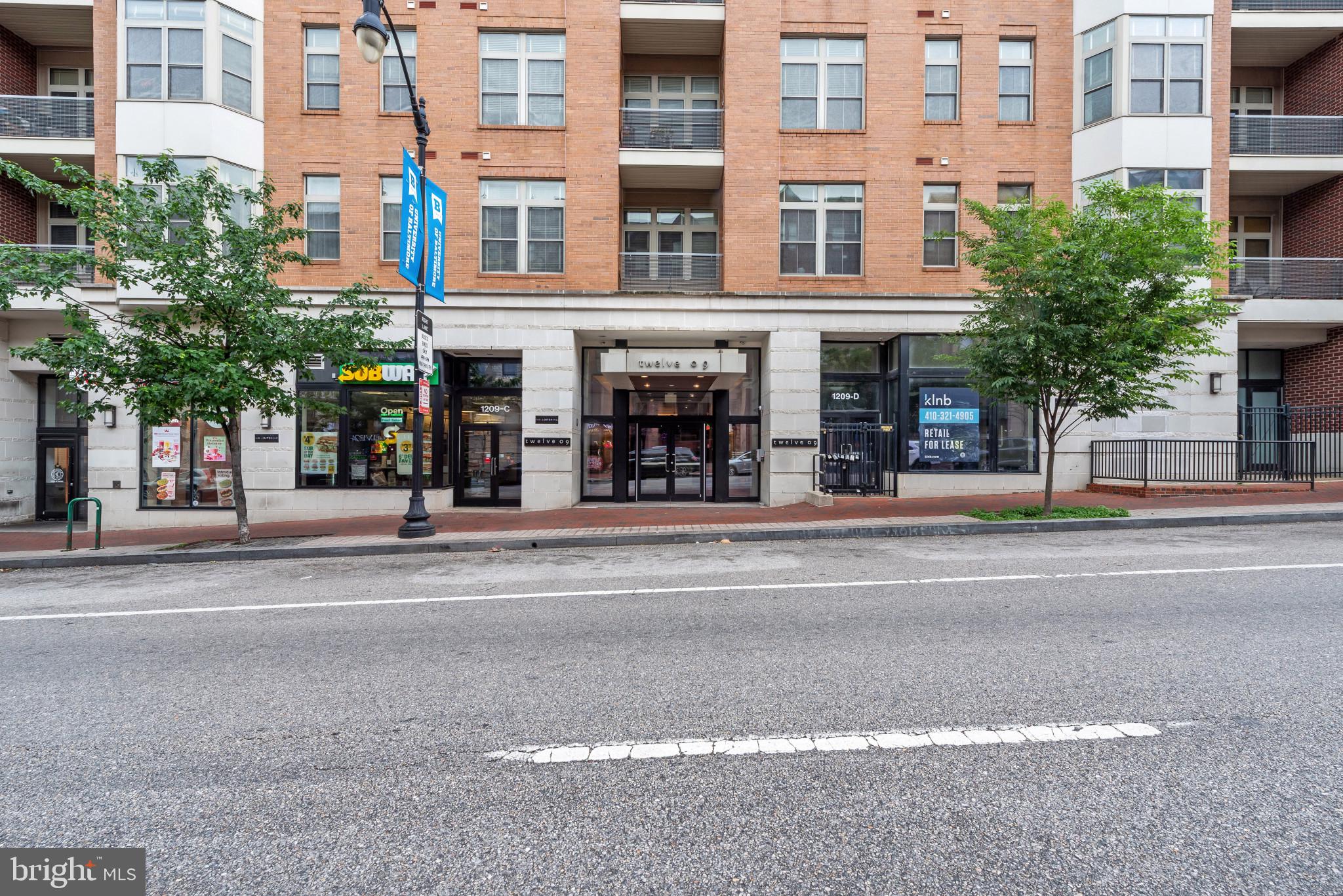 Experience elevated city living at 1209 N Charles Street #410 in the heart of Baltimore’s vibrant Mount Vernon neighborhood. This beautifully maintained one-bedroom, one-bath residence offers the perfect blend of comfort, convenience, and charm complete with a PRIVATE ROOFTOP DECK and ONE ASSIGNED GARAGE PARKING SPACE.Filled with natural light, the home feels bright, airy, and inviting from the moment you enter. The thoughtfully designed layout features IN- UNIT laundry, tasteful furnishings, and a well-kept interior ready for immediate enjoyment. Whether relaxing at home or entertaining outdoors on the PRIVATE ROOFTOP DECK, this residence offers a rare opportunity to enjoy city living with added privacy and style. Residence can come furnished or unfurnished and tenants pay electricity and Wi-Fi only.  Residents of the building also enjoy access to a charming courtyard and fitness center, adding to the convenience and lifestyle appeal of the property.Ideally located near Baltimore’s cultural, dining, and entertainment destinations, this home places you moments from local favorites, commuter routes, universities, and downtown amenities.Lease Terms & Application Guidelines:The future resident of 1209 N Charles Street #410 has a minimum lease term of 12 months and is invited to apply with a credit score of 620+ and verifiable monthly income. Up to two potty-trained and well-managed pets may be considered, with a maximum weight limit of 60 lbs each. Pet rent is $25 per month, per pet, in addition to monthly rent. Move in fee $400 to be paid and coordinated directly with building HOA management (for use of elevator for furniture if applicable) Residents must obtain renter's insurance w/100K value.