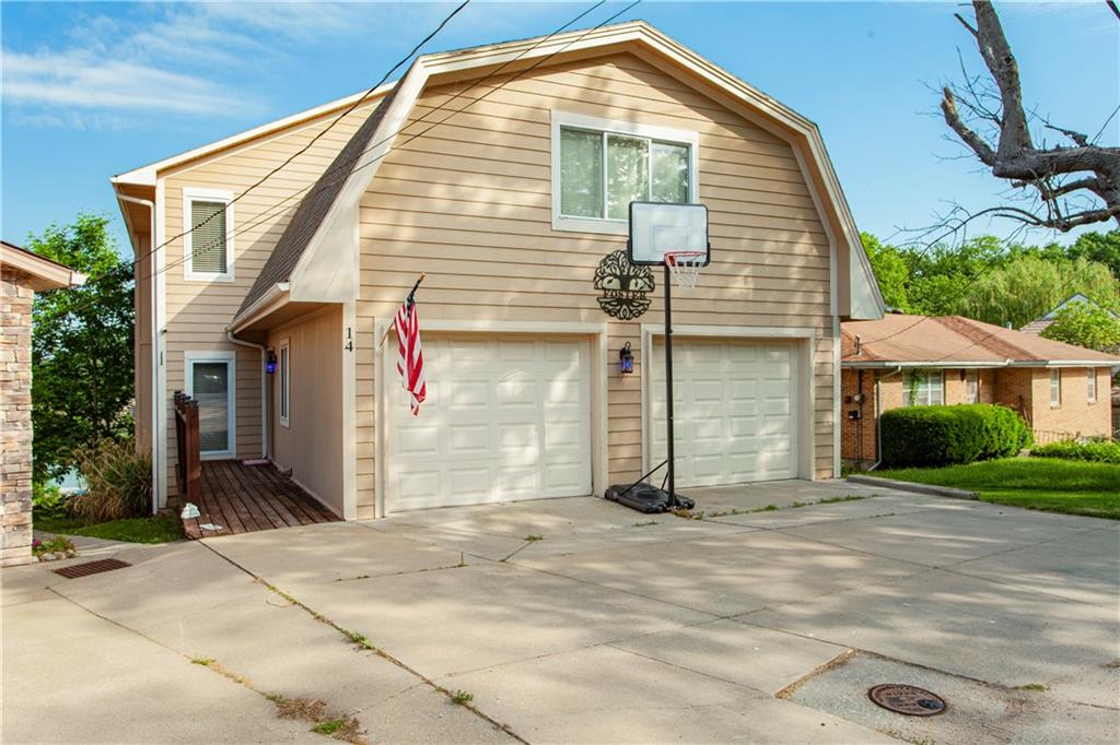 PRICED TO SELL for a First tier lake home within minutes of KC Metro. Enjoy lakefront living 365 days a year.Welcome to your lakefront retreat in the highly sought-after Lake Tapawingo Community! This stunning home offers over 3800 square feet of spacious living, perfectly designed for comfort, entertaining, and year-round enjoyment on the water.The massive primary suite, which is approximately 740 sq ft, is your personal oasis, complete with its own split cooling system for customized climate control when you want it extra cold, a large sitting area, private deck overlooking the lake, Large walk-in closet, primary bathroom, and plenty of room to relax and unwind in. Featuring 4 bedrooms, 3 Full bathrooms and 1 half-bath, this home has space for everyone. The main floor boasts gleaming hardwood floors, while the chef's kitchen is a true showstopper with white quartz countertops, stainless steel appliances (all staying), a walk-in pantry, and direct access to a second deck-perfect for morning coffee or evening entertaining.Enjoy the versatility of two full kitchens, ideal for multi-generational living or hosting large gatherings. A 2-car garage provides convenience, while the crown jewel of this property is your very own private dock with swim platform-step outside and hit the lake!Located close to shopping, dining, top-rated A+ Schools, and close highway access, this home combines lake life with everyday convenience without the drive.Best of all, enjoy a front-row seat to Lake Tapawingo's 4th of July fireworks display--right from one of your own decks! Display happens right in front of you.Whether you're looking for a year-round getaway, this move-in-ready home checks the boxes.Sellers are leaving a 2004 Sea Ray 180 sport boat, life jackets, and a lily floating pad that's already been quarantined & approved to be used immediately on the lake with an acceptable offer.Schedule your showing today before this affordable home is sold.