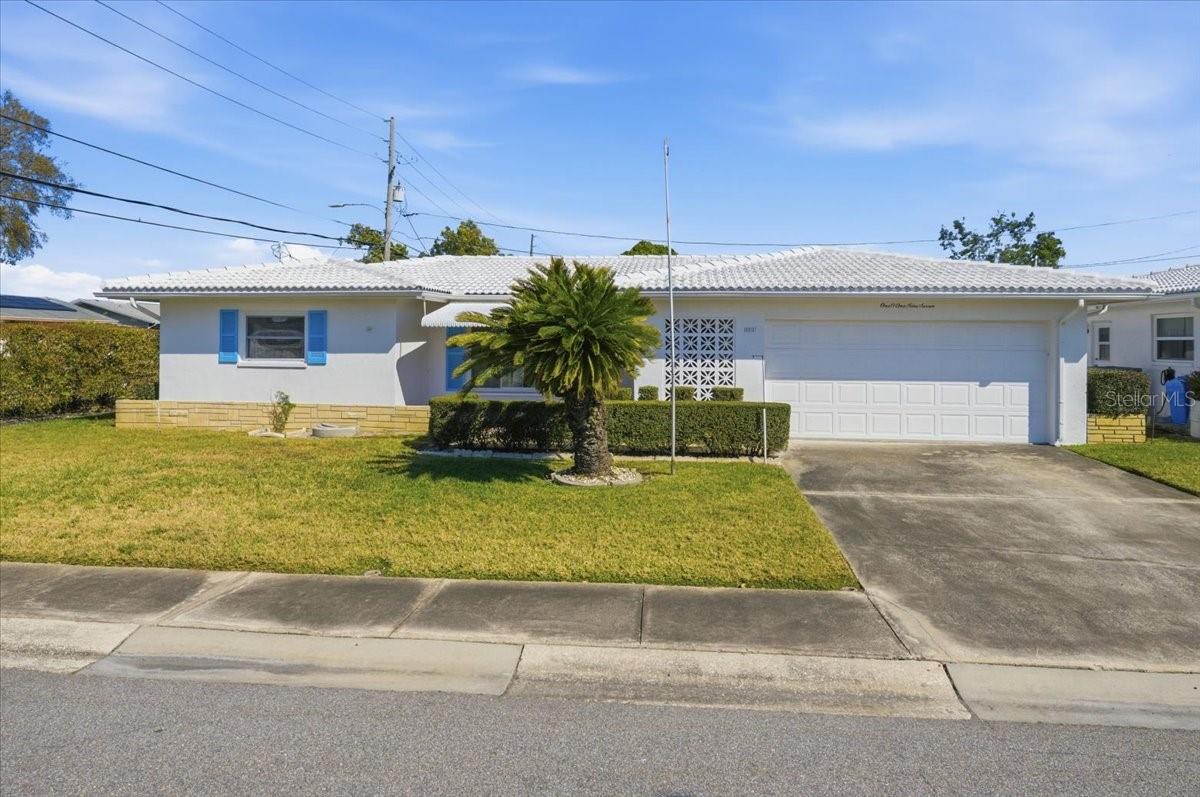 One or more photo(s) has been virtually staged. Welcome to 10197 44th St. N. A place where comfort meets opportunity in The Mainlands of Tamarac. In this established and beloved 55+ community, a two-car garage on a corner lot is genuinely uncommon — and this 1,705 square foot, 2-bedroom, 2-bathroom home offers exactly that. The residence is comfortable and move-in ready. Its design reflects an earlier era, and it is priced accordingly — meaning the next owner arrives with options rather than obligations. Update at your leisure, or simply settle in and enjoy the considerable value this home already delivers. The floor plan is thoughtfully proportioned: a formal living room alongside an expansive family room creates natural space for different rhythms of daily life. One of the most compelling aspects of this home is the remarkable peace of mind that comes with it. The HOA shoulders an impressive list of responsibilities that, in most communities, would rest entirely on the homeowner: roof replacement and maintenance, exterior painting, lawn care, the sprinkler system, cable television, internet, water, sewer, trash, and pool maintenance. Read that list again slowly — because it represents thousands of dollars annually that simply disappear from your worry list. The HVAC was installed in 2020 , meaning the home's essential systems are genuinely sound.The second garage bay deserves its own mention. Whether it becomes a home for the golf cart, a proper workshop, or the kind of organized storage that makes daily life run smoothly, that extra space proves its worth time and again. Step beyond your front door and the community reveals itself. The heated pool, recreation hall, and shuffleboard courts are a pleasant walk from home — as is the clubhouse, where neighbors become friends over a full calendar of social events. The Mainlands Golf Course sits right at your doorstep. Mayor's Park at Freedom Lake offers a beautiful natural retreat just moments away. Pets are warmly welcome here. And when the wider world calls, Gulf Coast beaches, premier shopping, and Tampa International Airport are all within easy reach.This is the kind of community where the amenities are genuinely lived in — and the lifestyle is genuinely earned.