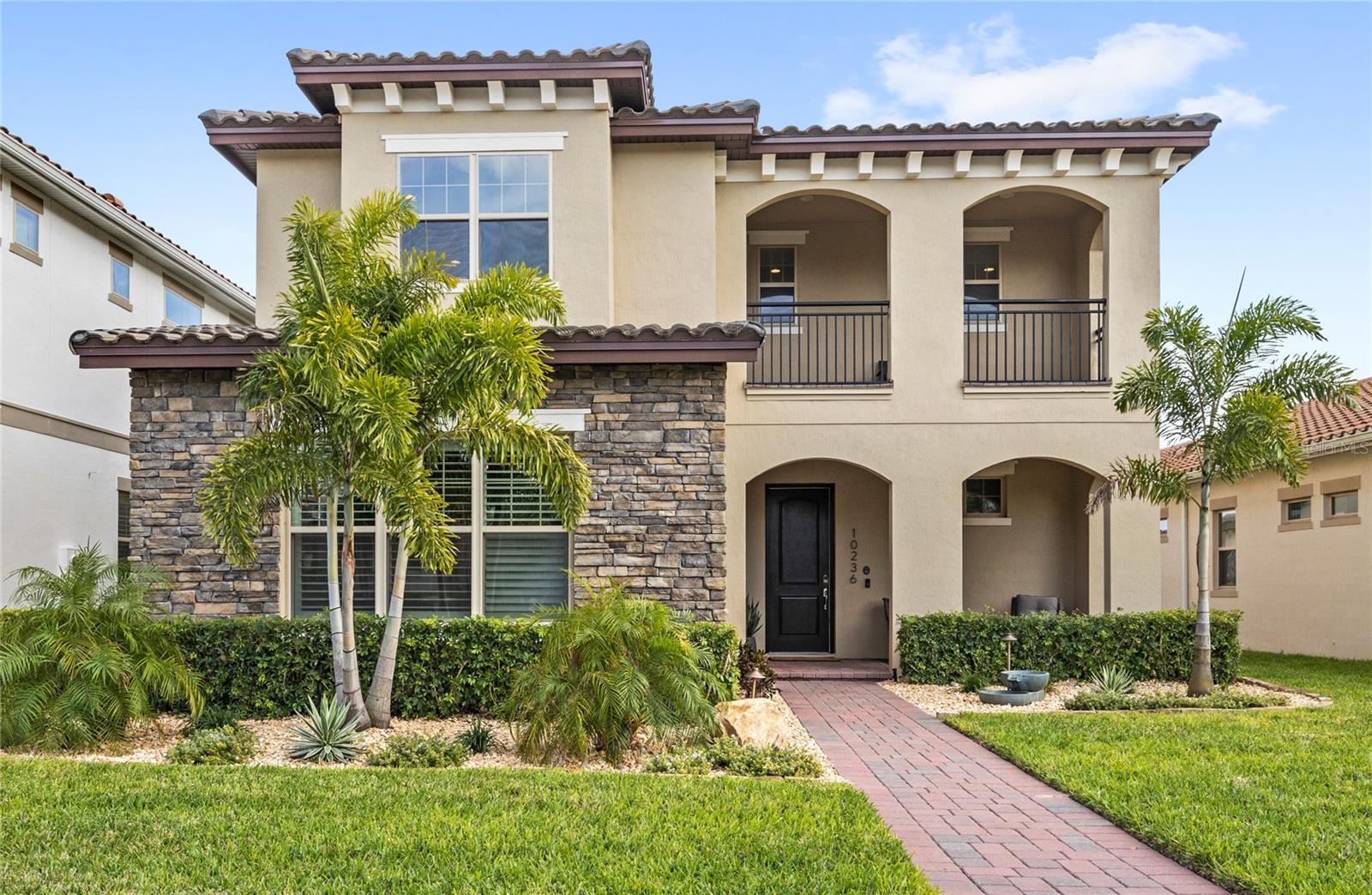 Better than New! Welcome to this stunning home nestled within the renowned Eagle Creek Golf Community in Lake Nona. This Mediterranean-inspired home showcases exceptional curb appeal with its elegant barrel-tiled roof and inviting covered front porch. Built in 2022, this expansive 4 bedrooms, 3.5 bathrooms Plus Flex room and over 3,400 sq. ft. offers a seamless blend of modern luxury with timeless charm. Upon entering, you’re greeted by an open-concept floor plan that effortlessly connects the gourmet kitchen, formal dining area, and generous living space—ideal for both intimate gatherings and grand entertaining. The chef’s kitchen is equipped with top-of-the-line appliances, custom cabinetry, and a large center island, catering to culinary enthusiasts. The main floor master suite serves as a private sanctuary, featuring a luxurious en-suite bathroom with dual vanities, a soaking tub, and a separate glass-enclosed shower. Additional bedrooms are thoughtfully designed, offering ample space and storage to accommodate family and guests comfortably. Living in Eagle Creek means enjoying a wealth of resort-style amenities. Residents have access to a championship golf course rated 4.5 stars by Golf Digest, a two-story clubhouse complete with a pro shop, lounge, and restaurant, as well as a family recreation clubhouse boasting a fitness center and gathering rooms. Outdoor enthusiasts will appreciate the resort-style swimming pool with an expansive sundeck, tennis and basketball courts, a covered playground, and a multi-purpose ball field. The community also features the Eagle Creek Elementary School, providing convenient educational opportunities for families. Strategically located in the Lake Nona area, this home offers proximity to top-rated schools, medical facilities, shopping centers, and dining options. With easy access to major highways, commuting to downtown Orlando and surrounding attractions is both quick and convenient. Experience the perfect blend of luxury, comfort, and community — a place you’ll be proud to call home. Schedule your private showing today.