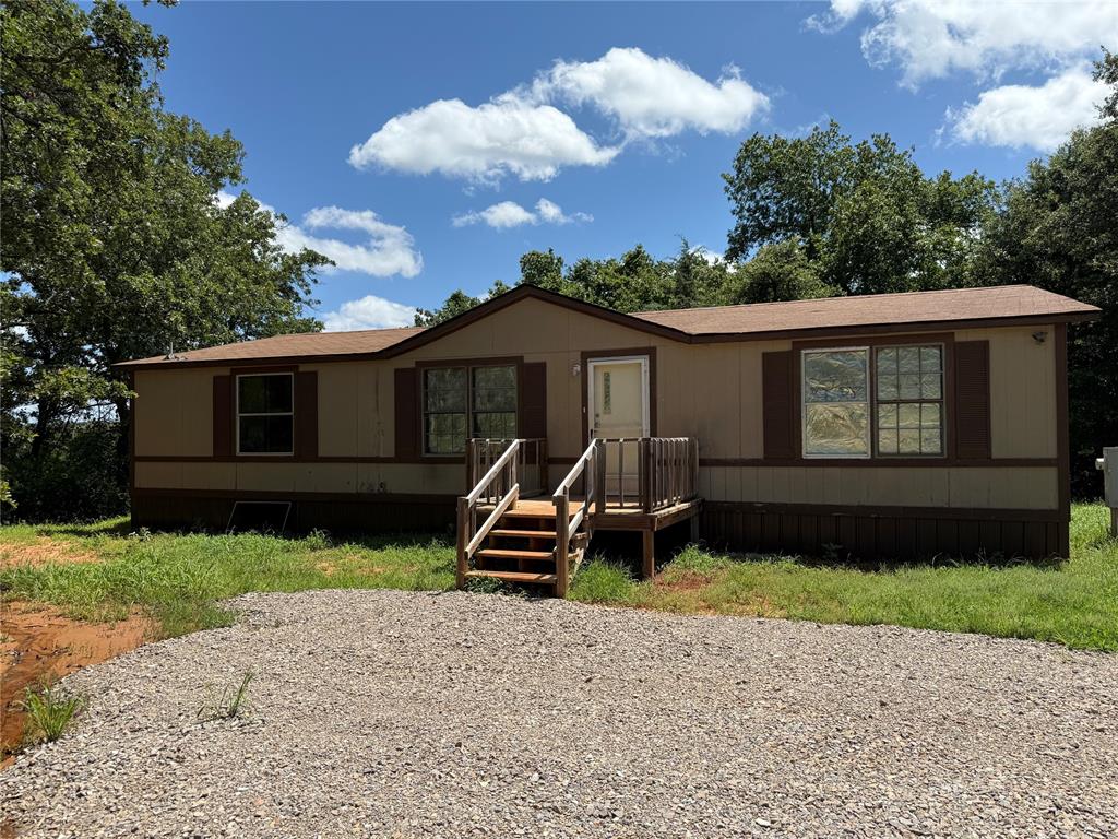 This property was split off from 8 acres at one time, but still shows that.  It is actually 1.25 acres, according to the seller. The mobile home has both bathrooms remodeled with newer tile work around showers in both baths. Floor was replaced in hall bath.  Kitchen has pantry & bar.  All 3 bedrooms have walk in closets.  Air conditioner was replaced at one time.  Home needs a little TLC & owner prefers to sell as is.  It is located on paved roads all the way, except driveway is gravel.  It's about 15 minutes to east Norman Walmart & other restaurants & stores in the area.  It's one of the cheapest acreages around the area.  West property is a few feet to the west of driveway.  There is a fence on the north side & the east side.