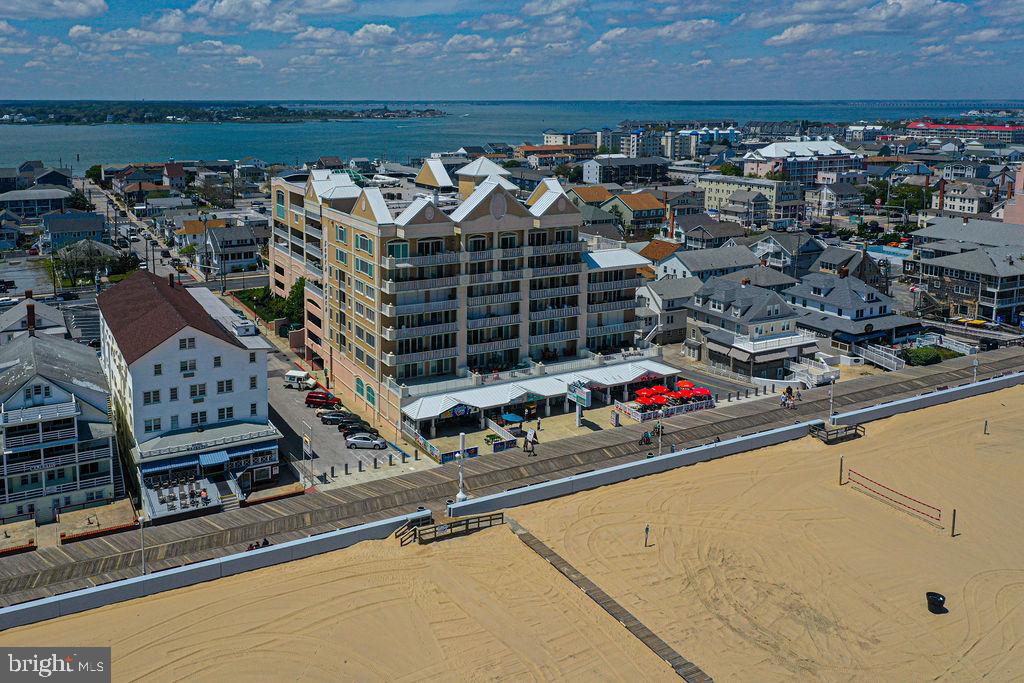 Experience the Best of Ocean City in This Premier One of a Kind Oceanfront Condo!  Welcome to #601 South Beach Boardwalk, one of the most exclusive and luxurious oceanfront condos in Ocean City with uninterrupted ocean & beach views, this 4-bedroom, 4.5-bath Boardwalk residence offers nearly 2,900 sq. ft. of elegant living space.  One of only 4 units in the building with this amazing floor plan.  Step inside and be amazed by the gourmet kitchen, featuring high-end Bertazzoni Italia appliances, granite countertops, a wine fridge, and designer finishes throughout. The spacious open-concept layout flows seamlessly to a 30' oceanfront balcony, perfect for sunrises, entertaining, or relaxing to the sound of the waves.  This rare unit offers two oceanfront master suites: One with a private balcony and gas fireplace and the other with direct access to the main oceanfront balcony.  Each of the additional two bedrooms features its own private full bathroom, offering comfort and privacy for all guests.  Additional highlights: Dual-zone HVAC systems, Two water heaters,  Electronic storm shutters on all slider doors, Includes 2 prime deeded parking spaces,  large private storage locker for beach gear, bikes, and more. You will be amazed with the room sizes.  Building amenities include: Indoor and outdoor pools, Fitness room, Secure lobby with controlled access.  As an Income-Producing Investment: This property is currently managed by OC Beachfront Rentals, with **guaranteed NET rental income of $120,000 annually—**with ZERO management fees. That means you’ll collect $10,000 per month.  Sold fully furnished and equipped so what you see is what you get!  Must see this before buying another luxury property.