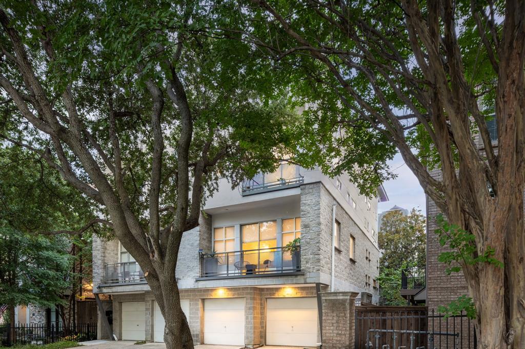 Discover a striking blend of modern architecture and effortless sophistication on tree-lined Bowser Avenue. This Oak Lawn standout breaks the mold, offering a multi-level layout designed for those who appreciate clean lines and thoughtful details. The heart of the home is an expansive living area centered around a sleek fireplace, flanked by custom built-in shelves that add both character and function. With built-in surround sound ready to go, the ambiance is always exactly what you want it to be. The kitchen is a chef’s dream, elevated by dual sinks, a dedicated beverage fridge, and premium finishes that make hosting feel like second nature. For those who work from home, the large study serves as a versatile light-filled flex space that adapts to your lifestyle. Retreat to a primary suite that feels like a high-end boutique hotel. It features its own fireplace for cozy evenings, a spacious walk-in closet, and a unique his and her style bathroom configuration for ultimate privacy. The real wow factor, however, waits at the top. The expansive roof terrace serves up panoramic city views that are hard to beat, providing the ultimate backdrop for sunset drinks. Outdoor living is woven throughout the design, featuring a private courtyard and three separate balconies. Best of all? You get all this style and luxury with zero HOA dues. It’s a rare find that manages to be as smart as it is beautiful.