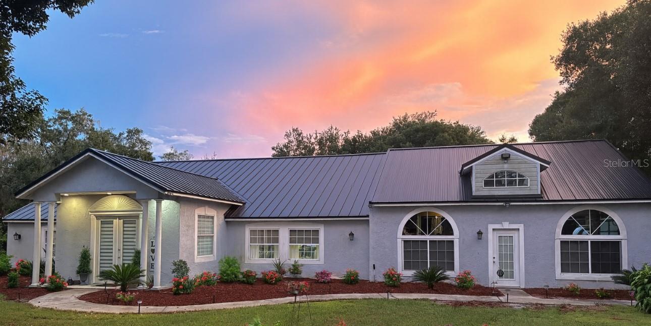 Price Just Reduced! One of a kind fully fenced one-acre estate is just minutes from Lake Nona and all Central Florida has to offer. Ideal for car enthusiasts and hobbyist this home features three garages with six bays, a breezeway workspace for additional vehicles, 50-amp upgraded electric service, compressor lines, and a full bath in one garage that can be utilized as an in-law suite or additional bedroom. Inside, enjoy 3 Bedrooms with family room, dinnin groom and family room, with features such high tin ceilings, crown molding,new tile floors, a built-in wet bar, movie/bonus room pre-wired for surround sound, formal dining, and a spacious kitchen with solid wood cabinets and premium appliances.The private master suite offers sliding doors to a seating area, large walk-in closet, and stylish ensuite bath. The lush grounds include pillar lights, a fire pit, a shed with water system, zoned irrigation on a separate well, and mature fruit trees. 2021 Roof , on septic tank and well.