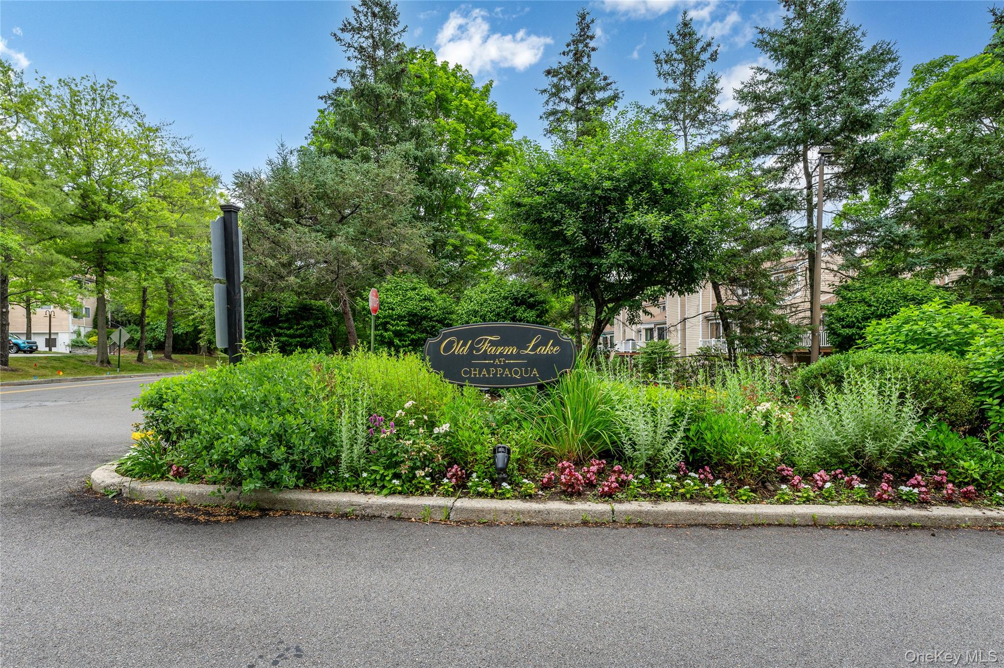 Offering over 1650SF of living space, this spacious townhouse in the sought-after Old Farm Lake community has private wooded views and an open, light-filled floor plan. The living room which is open to the dining area, features cathedral ceilings, a wood-burning fireplace, and sliding glass doors to a private deck. A renovated eat-in kitchen is well- appointed with granite countertops and stainless-steel appliances.  Additional on this level is a den/office and powder room. The second floor offers a spacious primary suite with cathedral ceiling, a custom organized walk-in closet and ensuite bathroom. The second bedroom also has an ensuite bathroom. Basement provides a great place for all of your storage. Enjoy resort-style amenities including a pool, tennis courts, clubhouse, paddle and basketball courts, and playground. Conveniently located in the Chappaqua School District, just minutes from shopping, parks, Metro-North, and an easy commute to New York City.