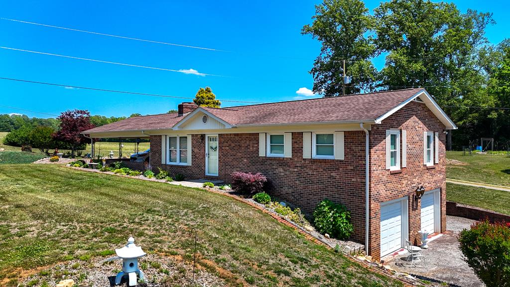 Located in scenic Patrick County, this beautifully landscaped brick ranch-style home offers comfort, convenience, and country charm all in one. Situated at 5910 Salem Hwy, Stuart, VA, this 2-bedroom, 1.5-bath home features a functional layout with plenty of space both inside and out.  The main level includes a  kitchen and dining combination, cozy living room, two bedrooms, and a full bath. One bedroom features two oversized walk-in closets, with a new washer and dryer conveniently located in one of the closets.  The finished basement offers additional living space with a welcoming family room complete with a wood stove, half bath, and another washer and dryer area. A built-in 2-car garage provides excellent storage. Recent updates include new kitchen appliances, new washer and dryer on the main level, and a new water heater installed in April 2026.  Step outside and enjoy the beautifully landscaped yard.  A lovely patio area provides an ideal space for morning coffee, reading a book or enjoying the peaceful surroundings. The property also features a double carport and a large 24' x 45' barn, offering excellent storage, workshop, or hobby space.  The golf cart currently stored in the basement will convey with the property, along with most of the furnishings, making this home move-in ready. Conveniently located just 10 minutes from the new hospital that opened in 2026, this property combines peaceful rural living with nearby amenities.