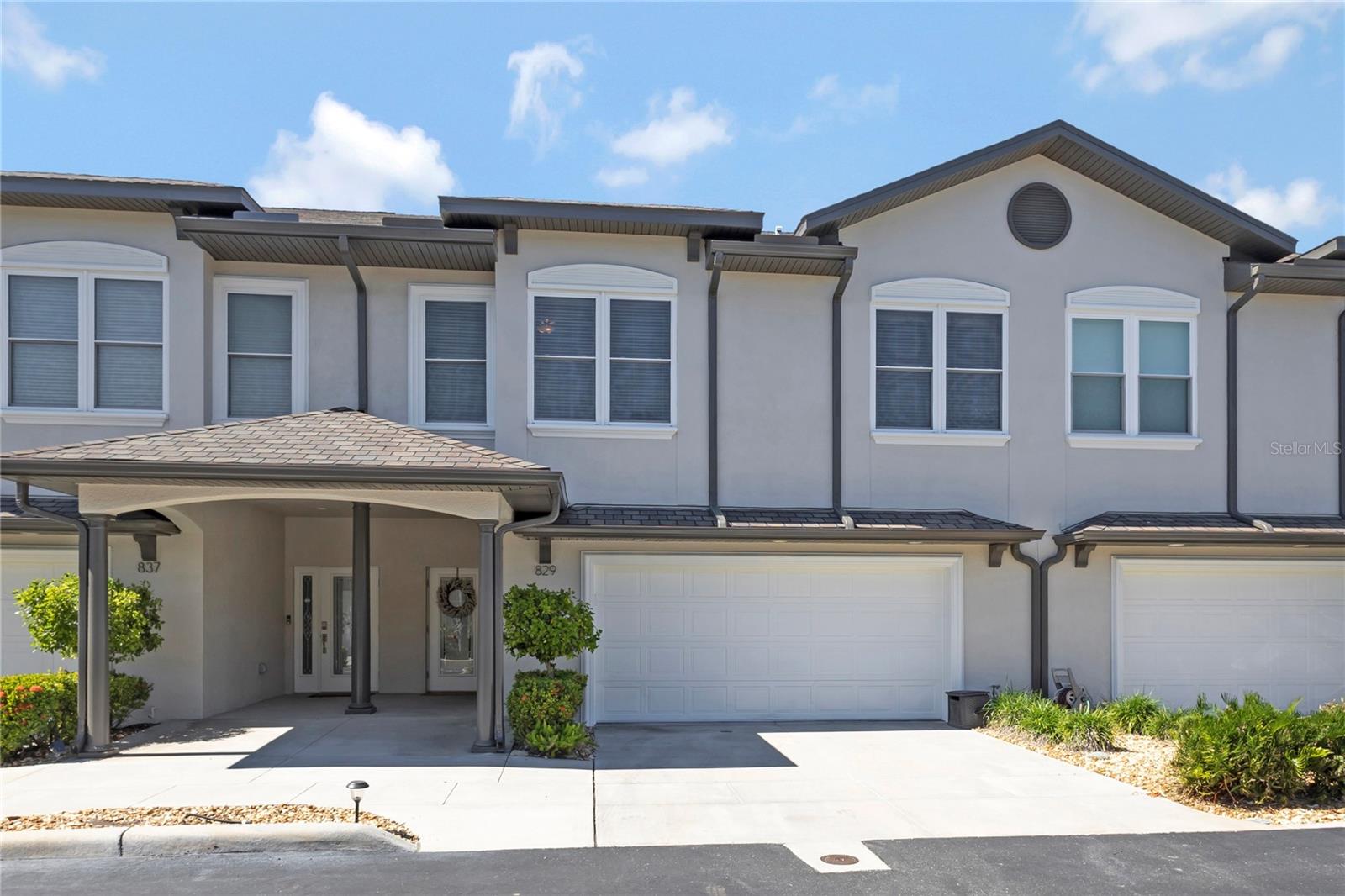Welcome to 829 Date Palm Lane, where spacious living meets coastal convenience in the charming, gated Villas at Date Palm community. Nestled within an intimate community of just 30 townhomes in desirable South Pasadena, this beautifully designed residence offers 2,590 square feet of living space, 3 bedrooms, 2.5 bathrooms, and the comfort of a single-family home with the convenience of low-maintenance townhome living.Step inside and immediately appreciate the impressive high ceilings and open-concept floor plan that create a welcoming atmosphere throughout. Beautiful neutral-toned ceramic tile flooring complements the spacious main living areas, while the generously sized living and dining rooms has plenty of space for everyday comfort and entertaining, where french doors lead to a private paver patio surrounded by tropical landscaping, creating a wonderful setting for morning coffee, outdoor dining, or simply enjoying Florida's beautiful weather.At the heart of the home is a beautifully appointed kitchen featuring striking sapphire and brown granite countertops, rich cappuccino cabinetry, a decorative stone mosaic backsplash, and stainless steel appliances. The spacious center island offers additional prep space and seating, while a built-in wine refrigerator, pendant lighting, and separate pantry add both style and functionality. Whether preparing everyday meals or entertaining guests, this thoughtfully designed kitchen is sure to impress.Upstairs, 9-foot ceilings continue the home's spacious feel. The oversized primary suite offers a private balcony, two generous walk-in closets, and a beautifully appointed en-suite bathroom featuring dual granite vanities, a deep soaking tub, and a frameless glass shower. Two additional spacious bedrooms feature ample closet space, while the generously sized upstairs landing provides a comfortable transition between the bedrooms and the convenient walk-in laundry room, complete with a utility sink.Additional highlights include hurricane-rated windows, an attached two-car garage, two additional driveway parking spaces, and abundant storage throughout. An oversized first-floor storage closet was originally designed to accommodate the potential installation of a residential elevator, offering added flexibility for future needs.Residents of Villas at Date Palm enjoy the privacy of a gated entrance along with wonderful community amenities, including a swimming pool, clubhouse, and fenced dog run. Conveniently located just minutes from St. Pete Beach, shopping, waterfront dining, and entertainment, this home provides easy access to everything that makes the Gulf Coast lifestyle so desirable.An additional highlight is the property's location in Flood Zone X, with no flooding reported during Hurricanes Helene or Milton in 2024, according to the seller.With its generous living spaces, thoughtfully designed floor plan, beautiful finishes, and exceptional coastal location, 829 Date Palm Lane offers an inviting place to call home. Schedule your private showing to discover all this wonderful property!