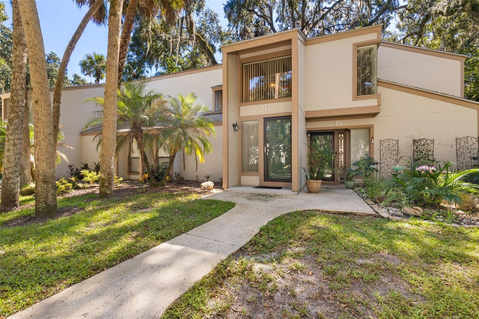 MOVE-IN READY 2-BEDROOM, 2-BATH CONDO IN A PEACEFUL WOODED SETTING! This beautifully maintained second-floor condo offers an open layout, new laminate flooring throughout the main living areas, tile in the wet areas, and fresh interior paint. Surrounded by a canopy of mature oak trees, this home provides a private, tranquil setting while still being conveniently close to shopping, dining, walking and biking trails, the Intracoastal Waterway, and area beaches.The spacious living room features large sliding glass doors leading to an enclosed lanai, creating a wonderful space to relax and enjoy the peaceful wooded surroundings. The kitchen offers a full complement of appliances, including stove, refrigerator, dishwasher, microwave, and a full-size stackable washer and dryer. Kitchen appliances, along with the A/C and water heater, were updated in 2016.The primary bedroom features an en-suite bath, a walk-in closet, and its own slider providing access to the enclosed lanai. The second bedroom and additional half bath offer flexibility for guests, a home office, or everyday living.Enjoy an active or relaxed lifestyle in this welcoming community, featuring a heated pool, clubhouse, tennis and pickleball courts, sidewalks, and walking trails. Whether you’re looking to stay active or simply unwind beneath the oak trees, there’s something for everyone.The HOA includes water, sewer, trash, cable, building and roof maintenance, landscaping, and interior and exterior pest control, providing added convenience and value. Located within convenient driving distance of St. Augustine, Ormond Beach, and Daytona Beach, this condo combines a private wooded atmosphere with easy access to beaches, dining, shopping, recreation, and the Intracoastal Waterway.Come see why this move-in-ready condo is the perfect place to enjoy Florida living—be as active or as low-key as you want!