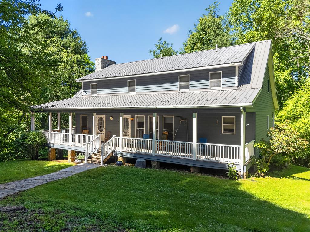 Escape to the mountain air of the Blue Ridge Mountains with this spacious 3,000+ square foot retreat on 6 acres at an impressive 3,200 feet in elevation. Surrounded by mature hardwoods and overlooking a picturesque pond, this property offers an exceptional blend of privacy, recreation, and comfort. The home features 5 bedrooms with potential for a 6th, 3 full baths, and 2 half baths, providing ample space for family, guests, or vacation rental opportunities. A massive stone fireplace anchors the living area, while the wraparound porch and deck invite you to relax and enjoy the peaceful setting. The spacious kitchen, generous bedrooms, and full basement provide room to spread out. Outside you'll find a detached two-car garage, additional storage shed, and abundant outdoor space. Located in Elk Creek and convenient to the Blue Ridge Parkway, New River, and Jefferson National Forest, this property is ideal as a primary residence, mountain getaway, or recreational retreat. Call today!