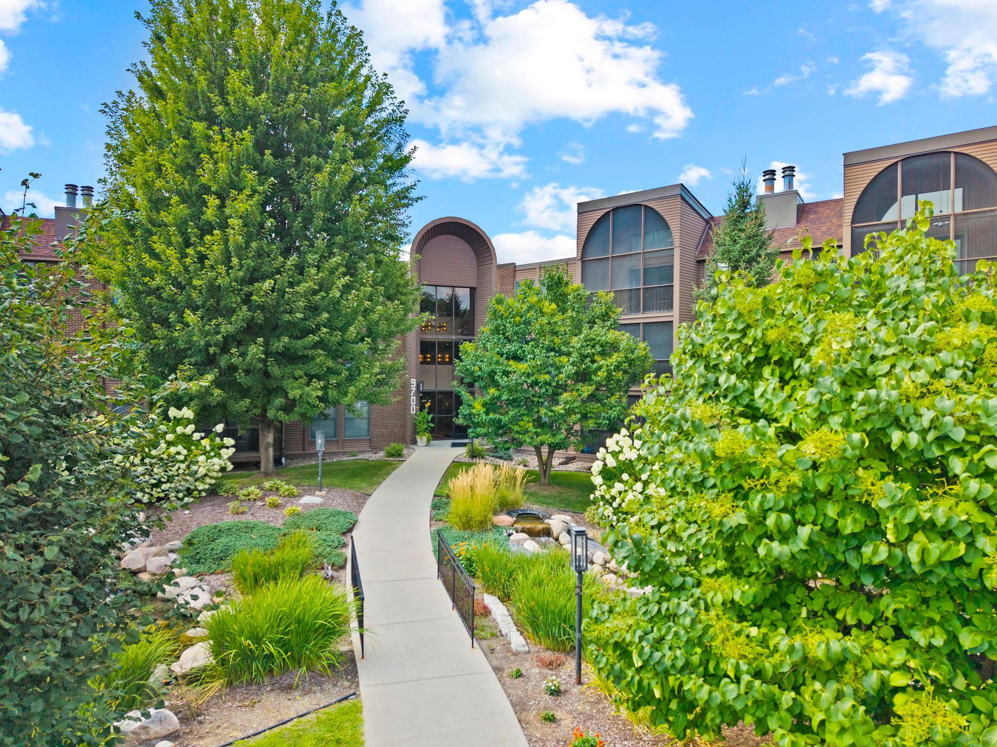 Charming 2-bedroom, 2-bath condo in a well-maintained Bloomington building with an all-inclusive HOA (heat included—owner pays only electricity). Enjoy top-notch amenities: indoor/outdoor pools, hot tub, sauna, tennis & pickleball courts, walking paths, community & party rooms, library, car wash, guest suite, workshop, heated underground parking, and extra storage. Just 5 minutes from Mall of America and 11 minutes to MSP Airport. This south-facing unit features soaring ceilings, a bright living room with gas fireplace, and a 13x5 screened-in deck with a brand new door. The kitchen has ample cabinetry, newer stainless steel appliances, and in-unit laundry. The primary suite offers a walk-in closet with custom built-ins and a private ¾ bath; the second bedroom is spacious with a full bath nearby. Comfort, style, and convenience combine in this thoughtfully appointed condo.