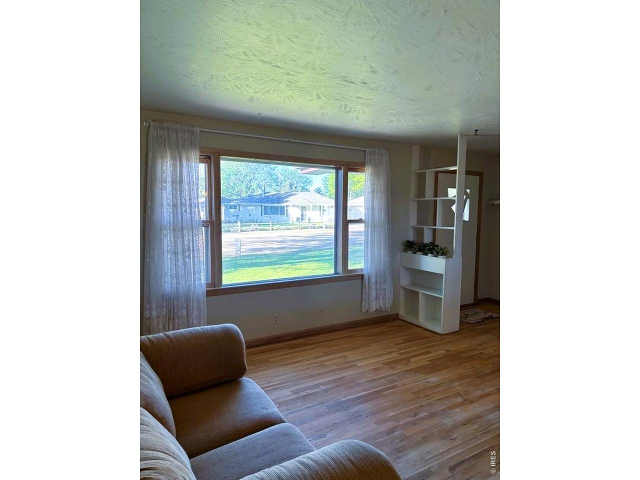 Original hardwood floors preserved for 66 years! Beautiful open living room that peeks through to the eat-in kitchen. In addition to an attached garage, this home includes a well-designed shop that allows additional parking, heated space, and endless DIY project opportunities. Beautiful fenced in yard with entrances on either side of the home and direct access from the dirt road behind. A must-see home located conveniently near local shopping with easy access to Highway 14.