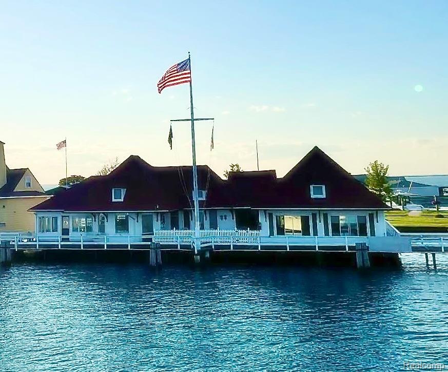 Escape to effortless summer living on beautiful Harsens Island, where timeless cottage charm meets the elevated lifestyle of The Old Club. Perfectly positioned along the St. Clair River, this light-filled retreat offers both privacy and connection — just steps from resort-style amenities and a vibrant calendar of family-friendly events.Thoughtfully designed for hosting, the home features a rare layout configuration ideal for welcoming guests. Each side functions as its own private quarters, complete with a full kitchen, two spacious bedrooms, two full baths, and comfortable living and dining areas. Whether entertaining extended family or hosting friends for the weekend, the layout provides the perfect balance of togetherness and privacy.A shared, expansive porch spans the river-facing side of the home — an inviting setting for morning coffee, sunset cocktails, and uninterrupted views of passing boats along the St. Clair River. A charming boardwalk connects you directly to the clubhouse, heated waterfront pool, newly renovated dining spaces, golf course, and both pickleball and tennis courts — creating a seamless indoor-outdoor lifestyle.Natural light pours through the home’s many windows, illuminating the serene river backdrop and enhancing the tranquil atmosphere throughout. Recent updates include new window A/C units, fresh interior paint, new carpeting, newer appliances, and a newer hot water tank — ensuring comfort and peace of mind.The property also includes one dedicated golf cart garage space, making island living both easy and convenient.A rare opportunity to own a turnkey summer cottage in one of Michigan’s most exclusive private island communities — where every day feels like a getaway.