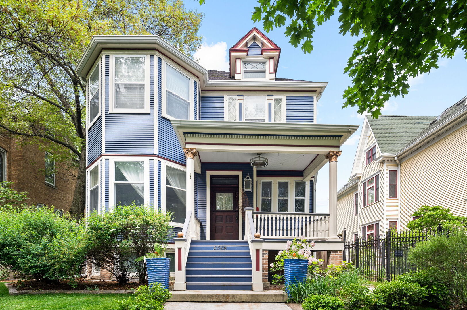 Step into history in Uptown/Sheridan Park's storied Dover Street Landmark District. Commissioned by A. G. Synnberg and built by Russell Powell in 1898, this original Queen Anne wood-frame residence sits on an extraordinary 50x195 lot-offering space, privacy and tranquility rarely found in the city. Thoughtful updates blend seamlessly with preserved architectural details, from the dramatic front staircase and pocket doors to intricate mouldings and original stained-glass windows. The gracious main level features an inviting foyer, formal living and dining rooms, and kitchen outfitted with premium JennAir appliances-including panel-front refrigerator and dishwasher-plus a Viking built-in oven, granite countertops, and custom cabinetry. French doors off the dining room open to a large deck overlooking the professionally landscaped backyard, where multiple entertaining areas-deck, patio, and gardens-create a private oasis. Upstairs are three bedrooms and two updated baths. The serene primary suite features a walk-in closet and an en suite bath complete with dual vanities, walk-in shower, and lots of cabinetry and storage space. The finished attic offers flexible space for a bedroom, studio, office, or playroom. The fully finished basement is the perfect place to entertain or hang out, which includes a rec room with adjacent bar area, bedroom with egress windows, full bath, laundry room, wine cellar, and additional storage. Mechanical updates include Carrier HVAC and roof (2021) and Renewal by Andersen basement windows (approx. 2020). A detached two-car garage and three additional parking pads (with rental potential) complete this remarkable property. Everything Uptown has to offer is right outside the door. The location cannot be beat. Walking distance to some of the best music and entertainment like the Aragon Ballroom, Riviera Theatre, and the famed Green Mill Tavern for jazz enthusiasts. Excellent dining options along Broadway, Clark and Wilson Street corridors, and everything Andersonville has to offer just around the corner. The lakefront and Lake Shore Drive are less than a 5 minute drive away. Public transit is a breeze here with many bus options on Clark, Lawrence, and Broadway, or take the CTA Red Line at the newly renovated Lawrence Avenue station. Mariano's grocery store is a few blocks away, across from the Lawrence Avenue Metra Station, which is a quick ride downtown!