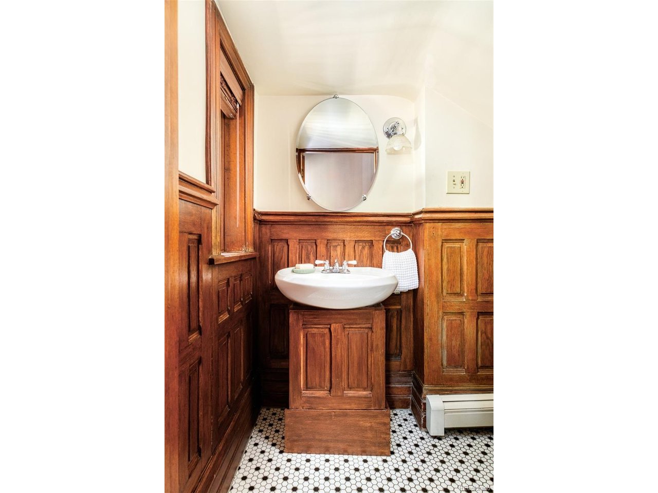 Steeped in history, exuding century-old charm with modern, thoughtful updates, 929 N Pearl is nothing short of spectacular. This turn-of-the-century Victorian mansion sits on three lots and features six bedrooms, five bathrooms, and 5,244 finished square feet. With rich tones, high ceilings, five fireplaces, hardwood floors, a carved wooden staircase, and original built-ins, the home preserves its old-world character while seamlessly supporting modern living. The bright, open kitchen has a large island with marble countertops and a one-of-a-kind brass backsplash. Breakfast nook doors with motorized shutters open to the expansive yard, extending gathering spaces outdoors, while a mudroom provides convenient access from the detached garage. The dining room built-ins and ceiling details elegantly hearken back to a bygone era. The front living room, grand staircase, and entryway enchant visitors and are a source of pride for the owners. On the main floor, a flex space sits adjacent to a powder room with a rare pillbox toilet and a staircase leading to the basement. Upstairs, the primary bedroom includes a sitting room with a windowed alcove and en-suite bathroom. Three large bedrooms, a full bathroom, utility room, and a deck complete the second floor. The third floor offers a huge loft, clever storage solutions, a beautiful sunlit 3/4 bathroom and fifth bedroom with exposed brick. The newly finished permitted basement is accessed via the flex space stairwell or from a private entrance in the backyard. Designed as private quarters, it has a bedroom, full bathroom, theatre, exercise room, and under-stair storage. Located in the Historic District of Capitol Hill, one of the special notes of this home is that all renovations were completed for the owners, as they planned for it to be their forever home; the result is enduring quality, timeless design, and exceptional attention to detail throughout. Own a piece of Denver history with this charming, unique, and classic home.